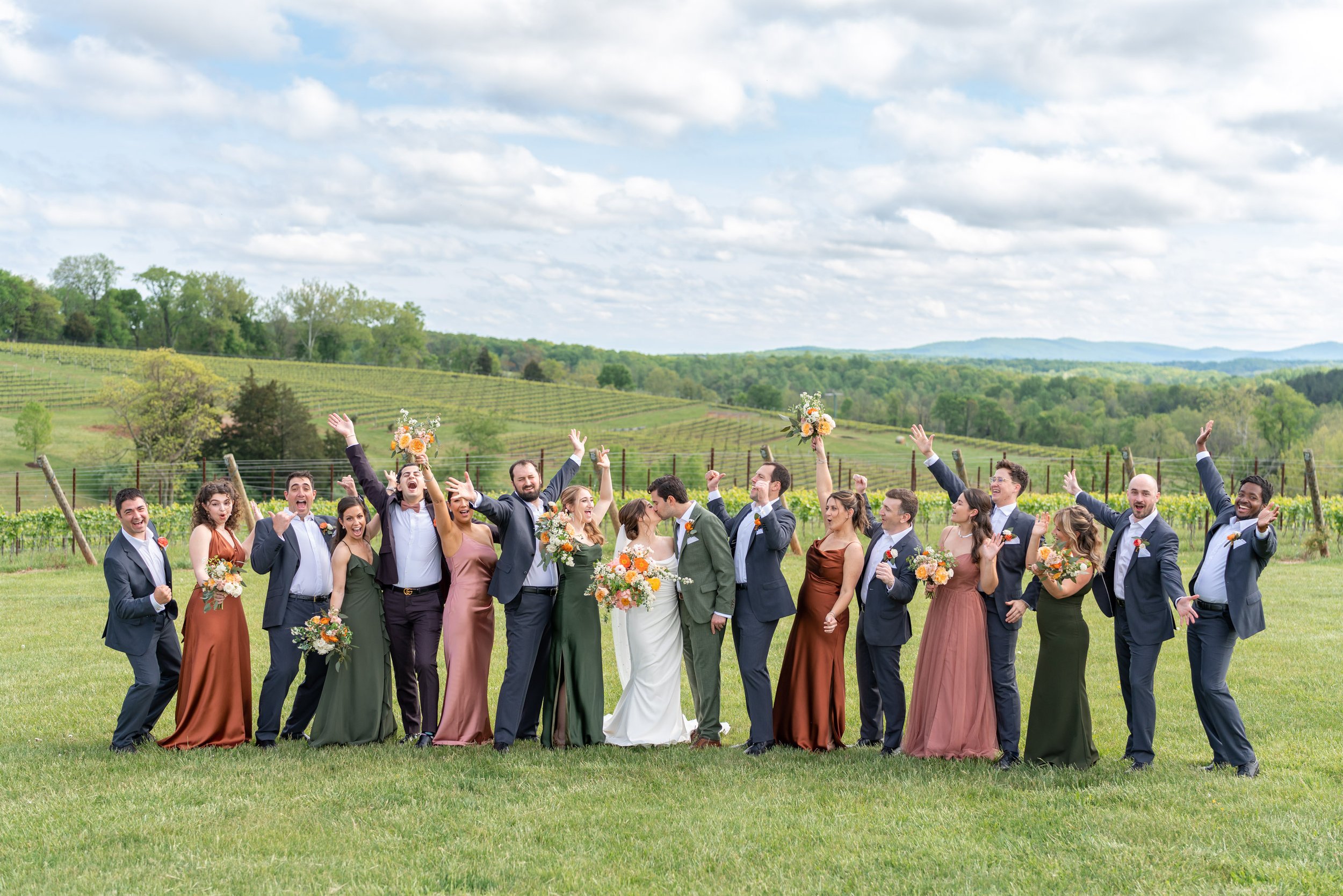 Bridal party celebrating photo at Stone Tower Winery on hillside