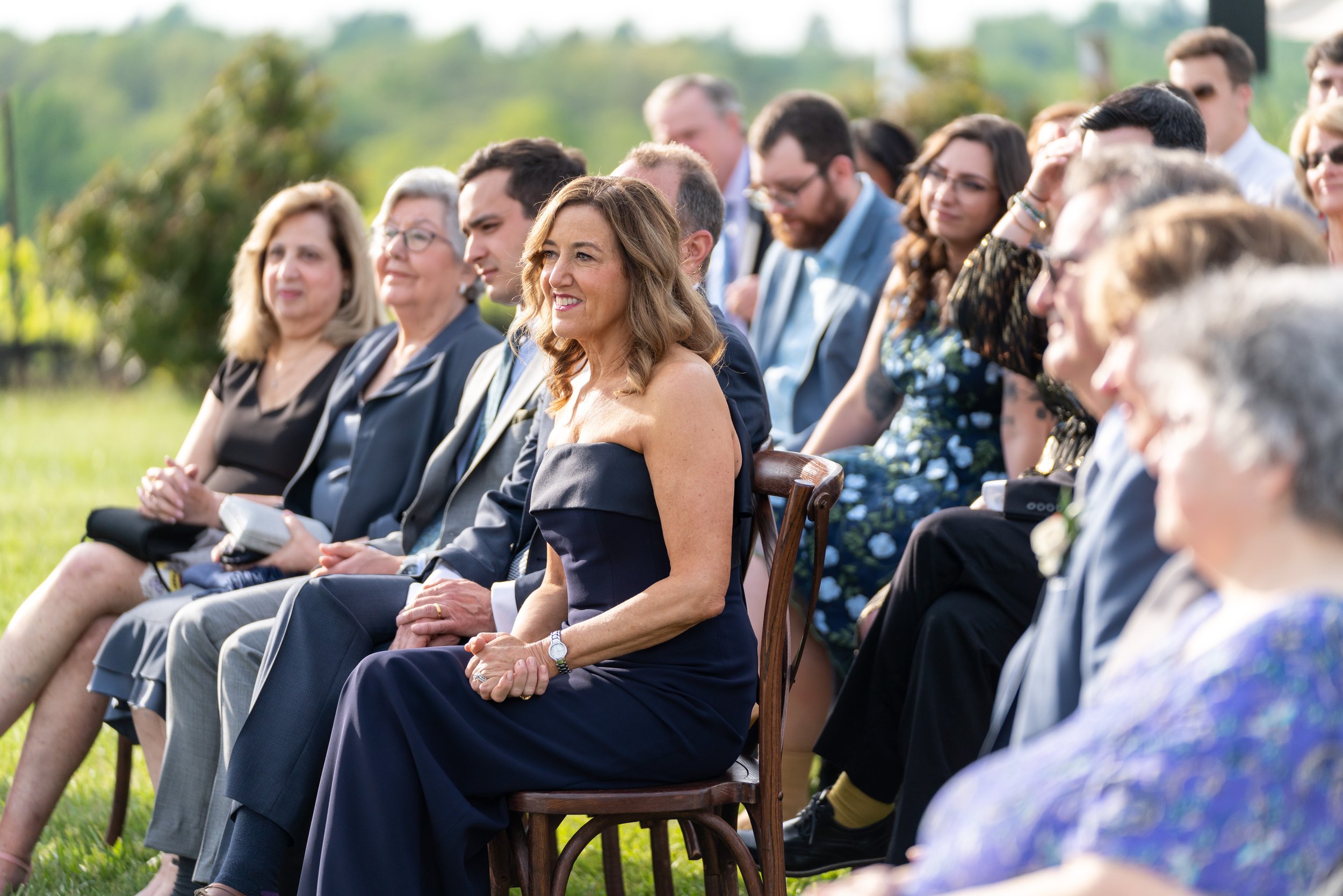 Mother of the bride listening to the wedding vows and smiling