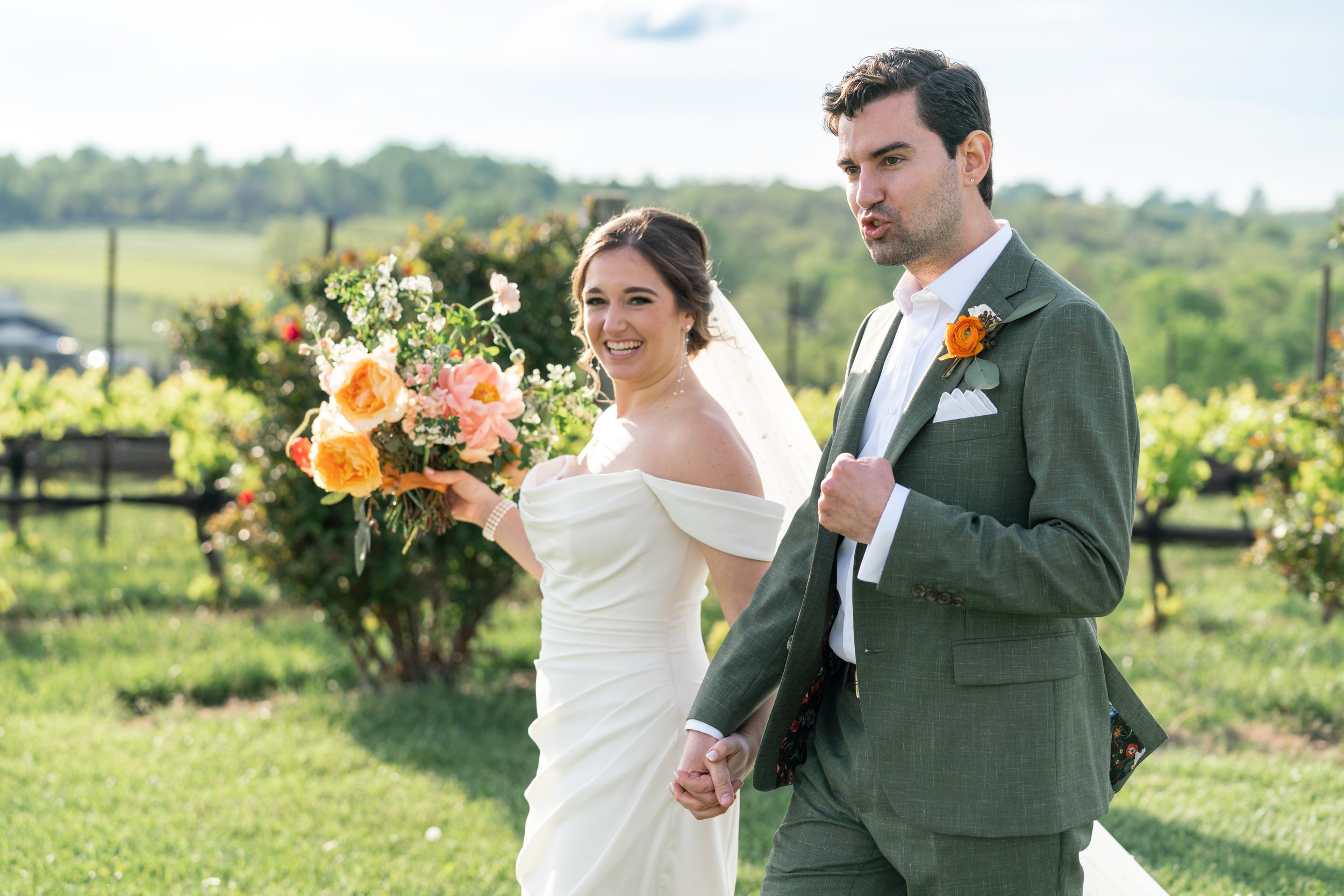 Bride and groom celebrate in the vineyard at Stone Tower Winery