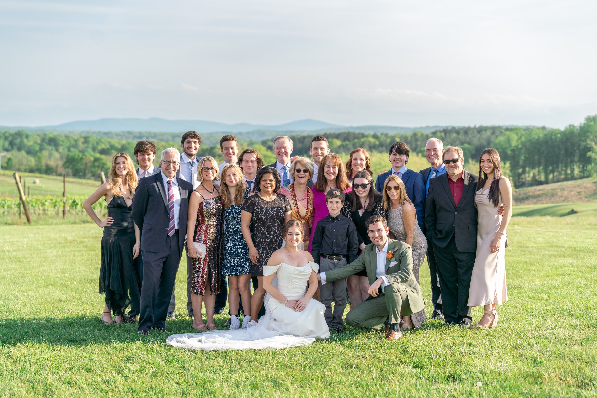 Bride and groom with wedding guests during cocktail hour outdoor reception