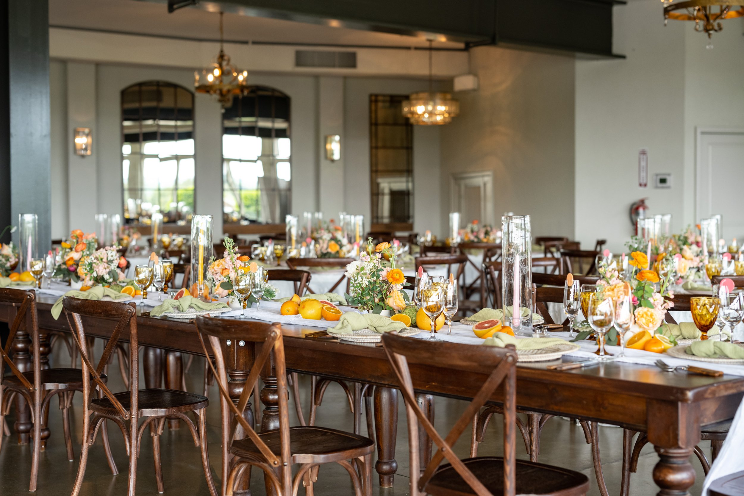 Citrus and artichoke themed wedding decor tables at Stone Tower
