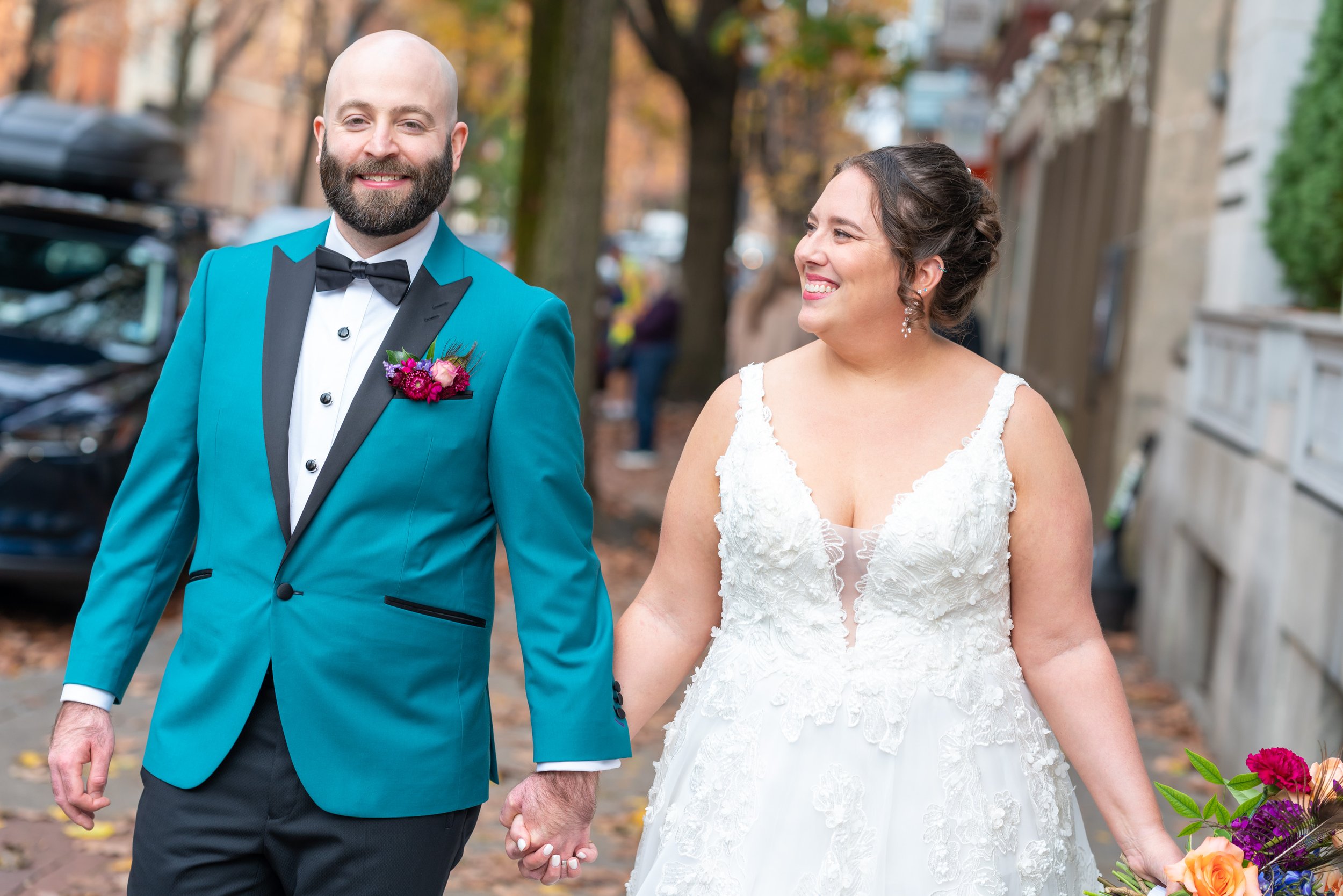 Bride and groom portraits walking down street in fall wedding at Citizen's Ballroom