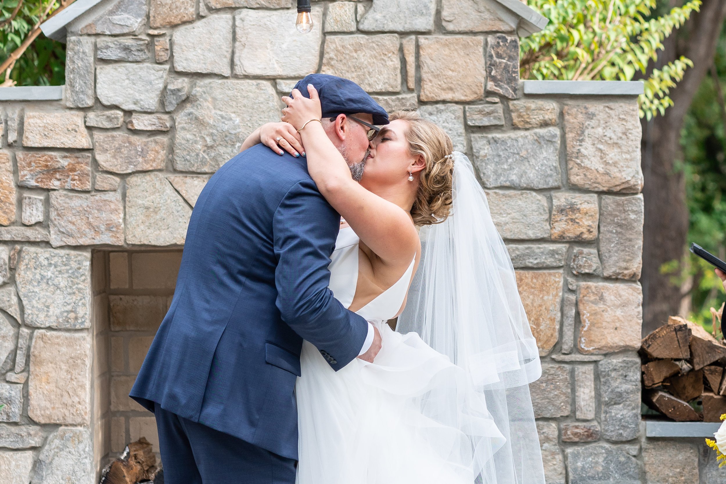 Bride and groom kiss at end of wedding ceremony