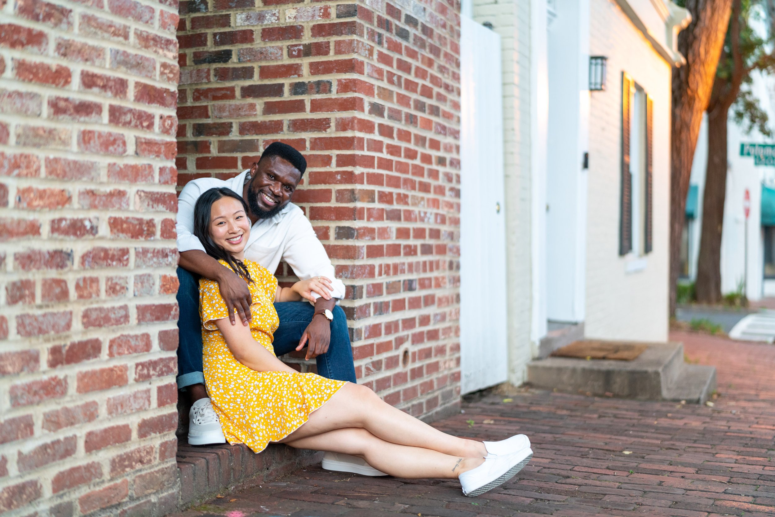 Bride and groom sit on brick stoop in DC Georgetown summer