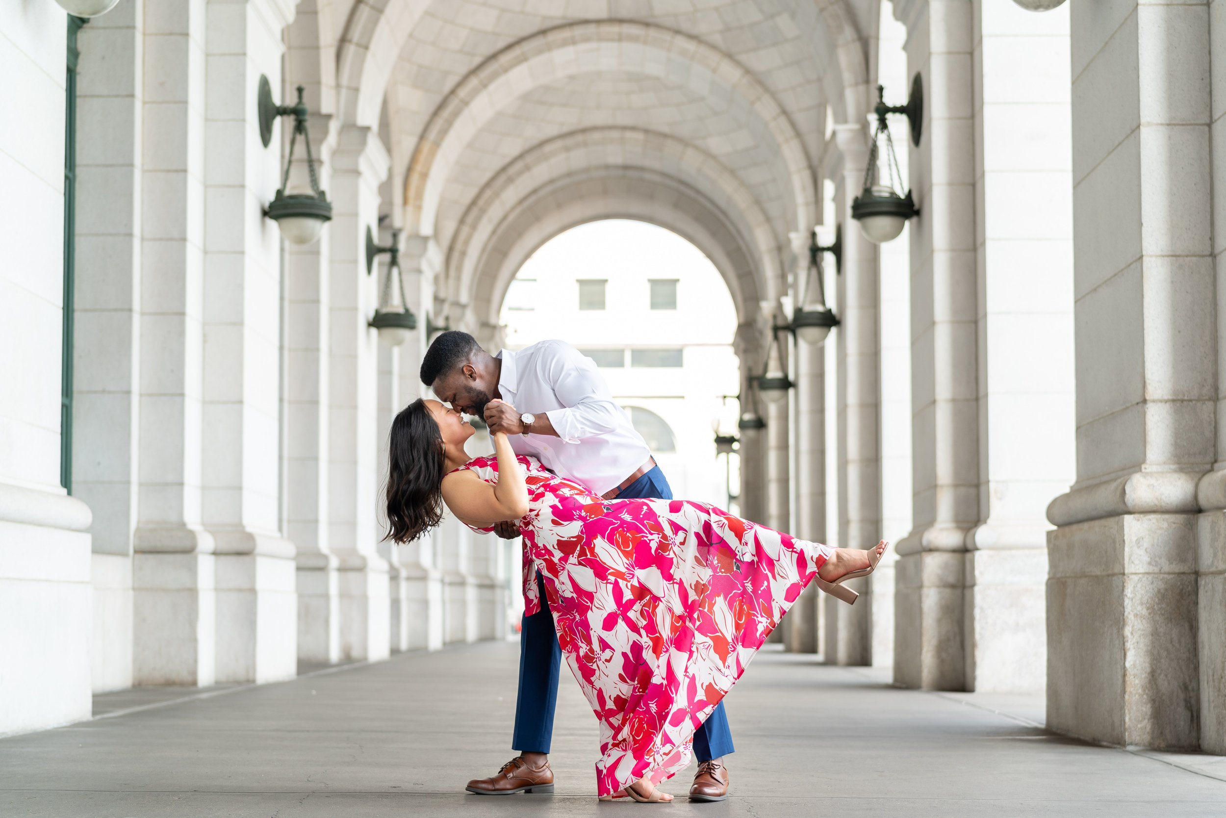Groom dipping bride at dc union station engagement session
