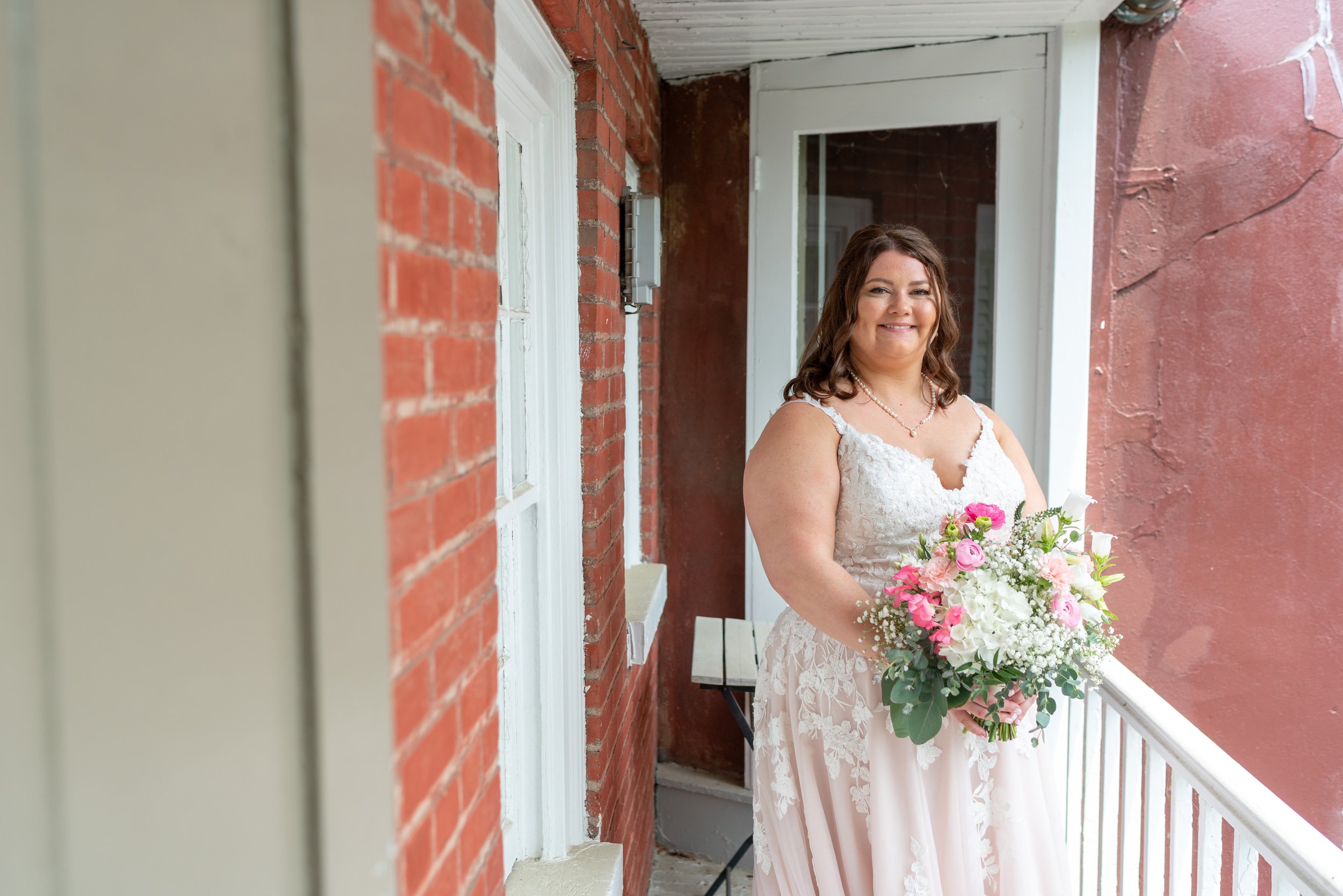 Bride on balcony on Carroll Creek in Frederick Maryland