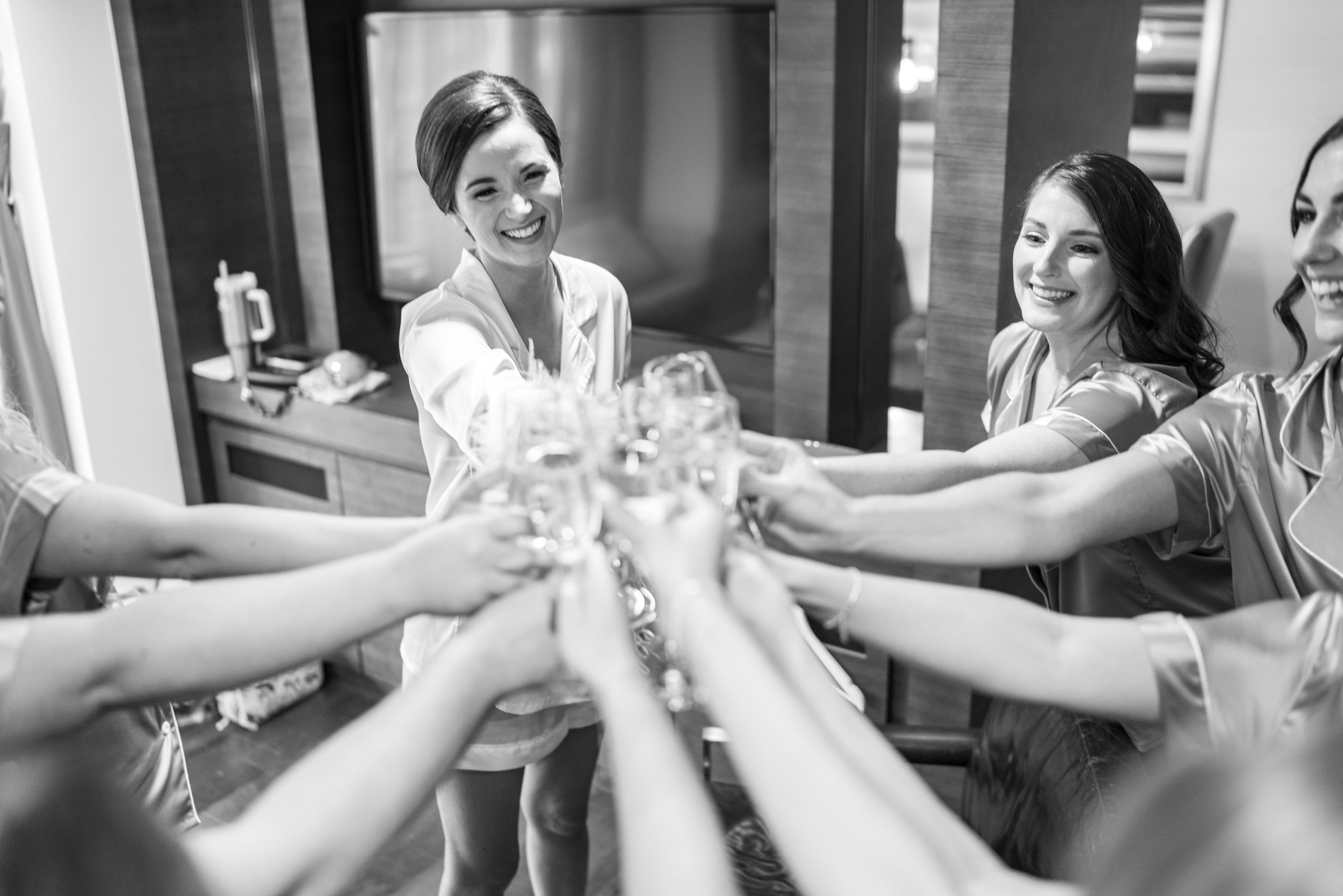 Bride and bridesmaids toasting champagne at fun wedding at DC Grand Hyatt