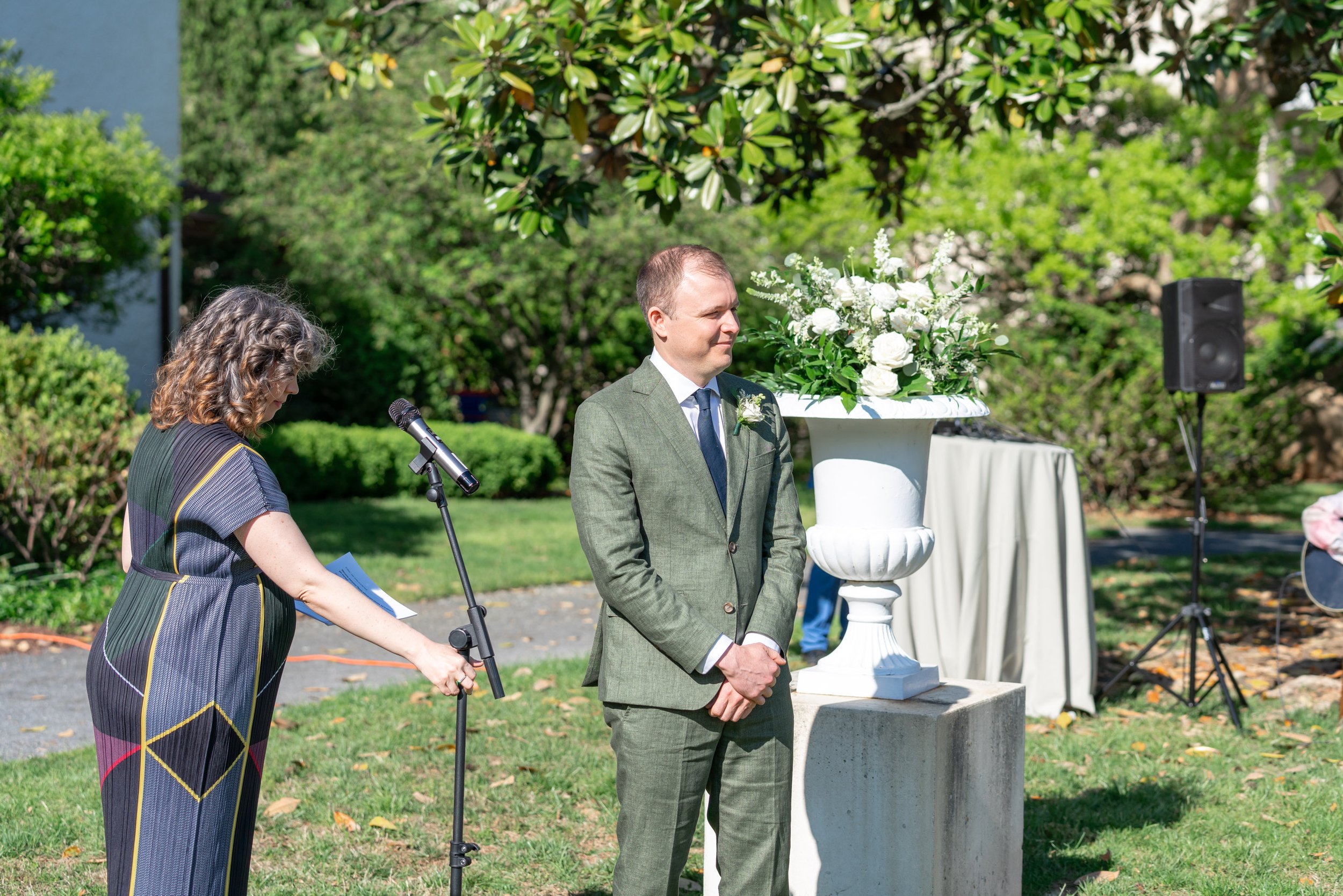 Groom watching bride walk down the aisle at summer wedding at Lincoln's Cottage