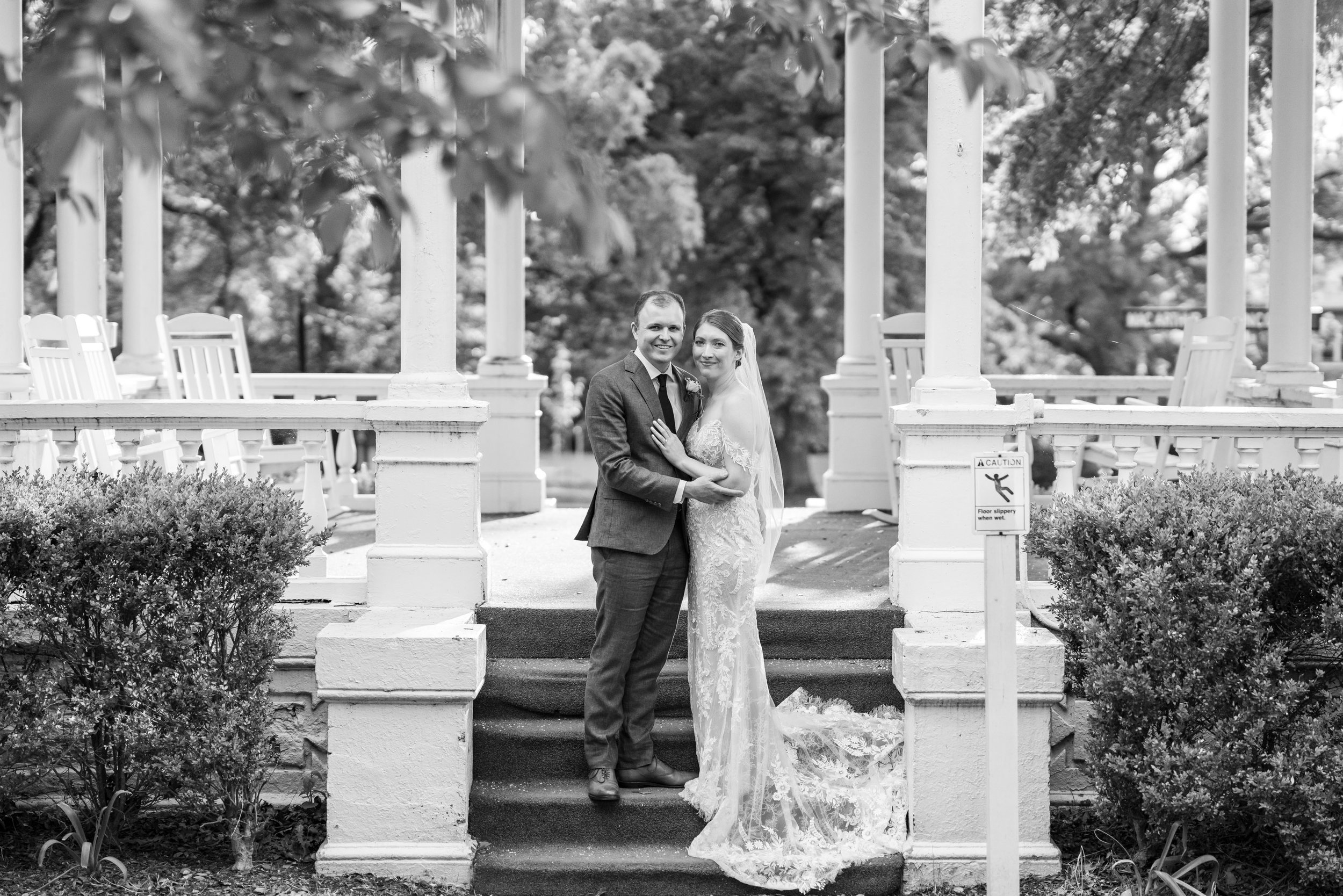 black and white photo of bride and groom on gazebo at Lincoln's Cottage