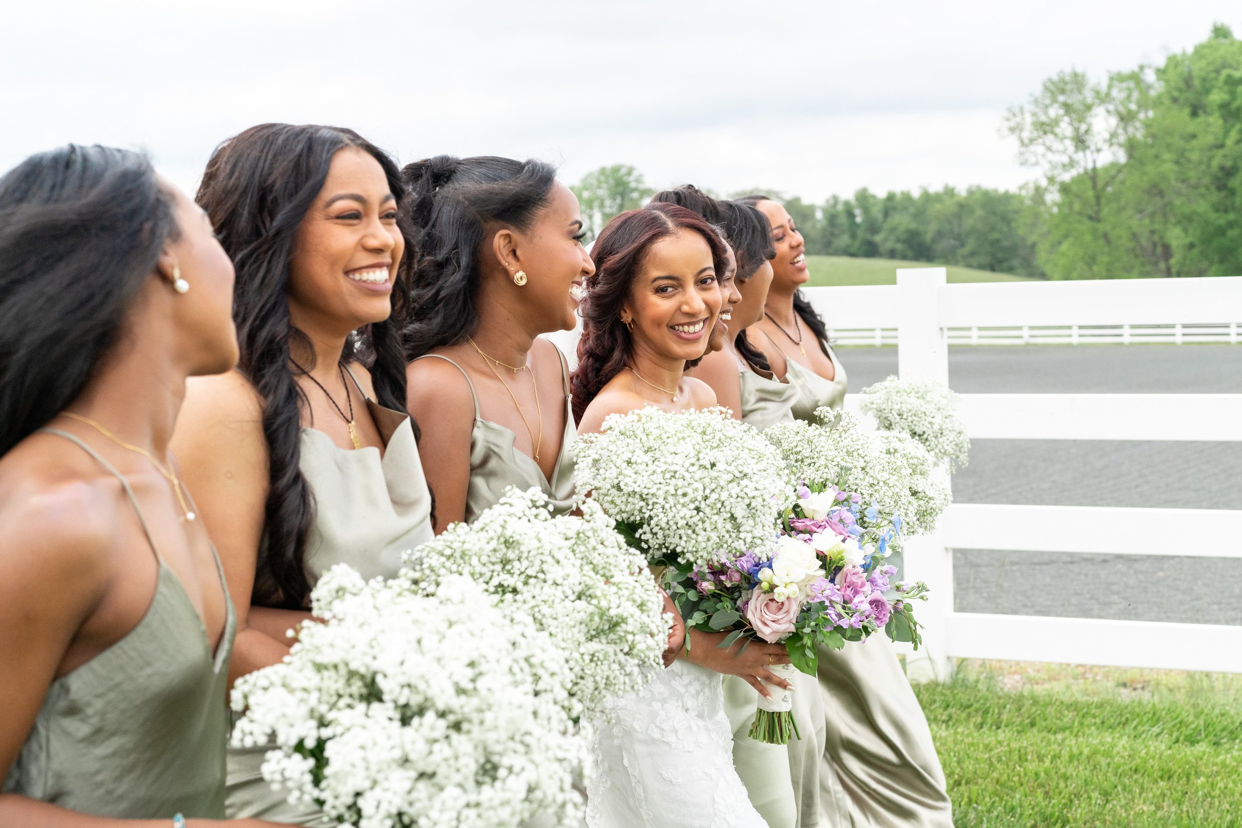 Bride and bridesmaids laughing and walking at Vignon Manor Farm wedding