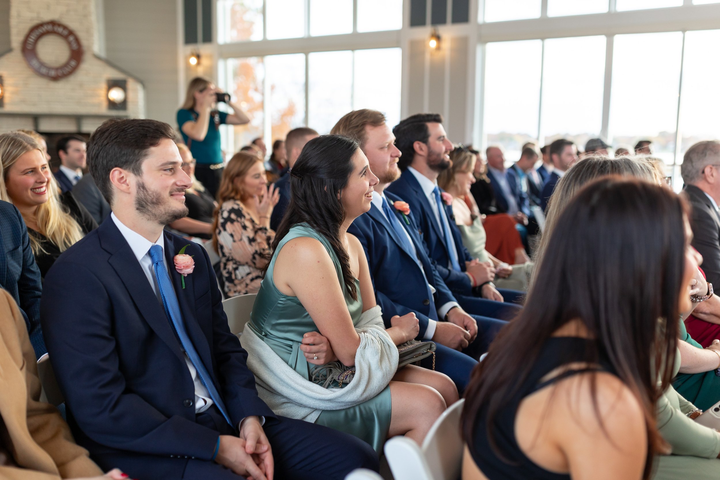 Guests laughing and smiling during wedding ceremony at Chesapeake Bay Beach Club