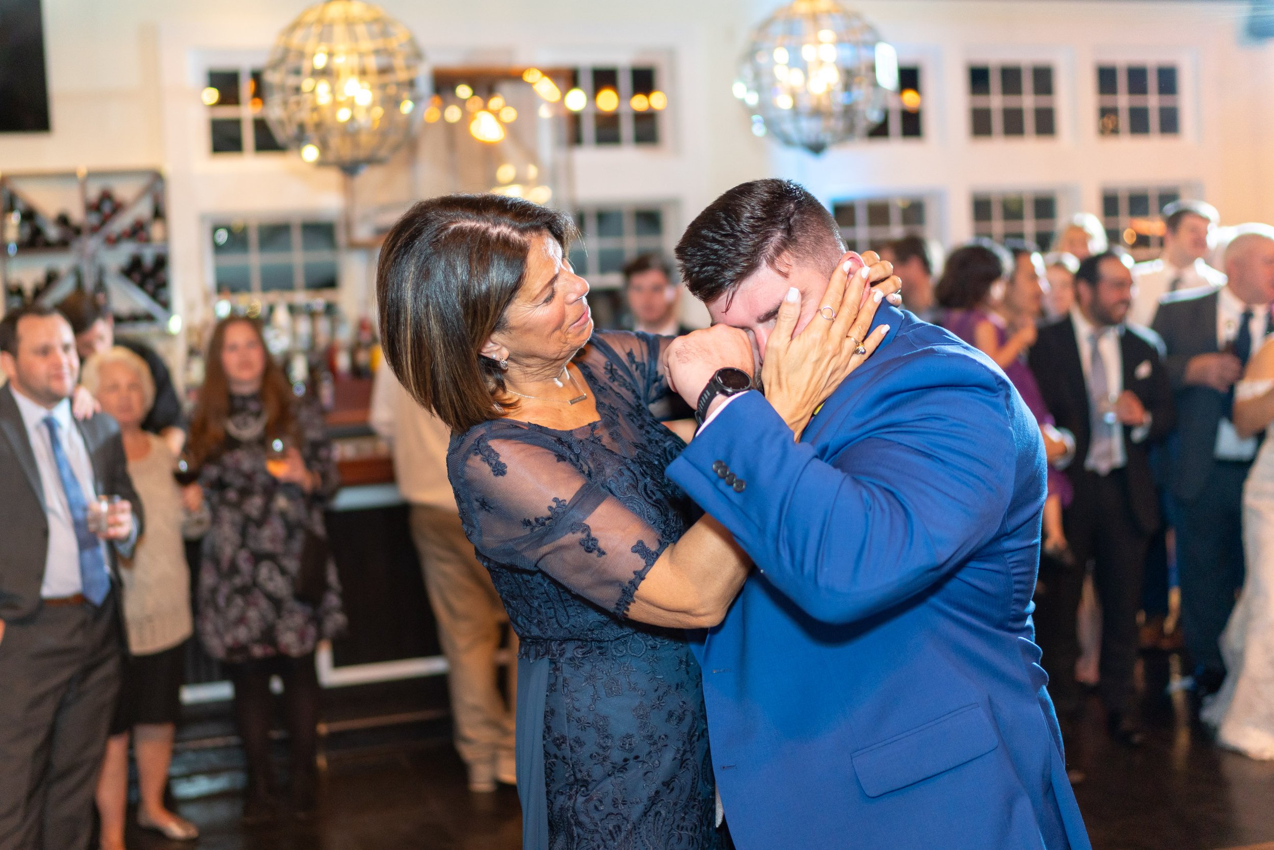 groom cries during mother son dance at Chesapeake Bay Beach Club