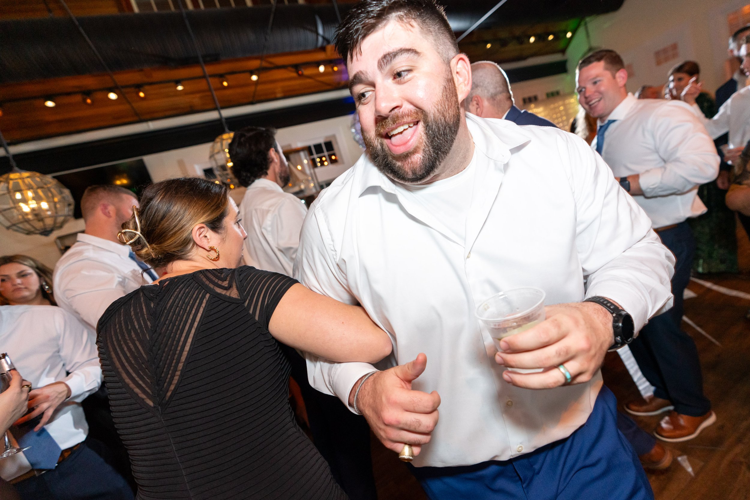 groom dancing with guests during reception at the fun Chesapeake Bay Beach Club venue