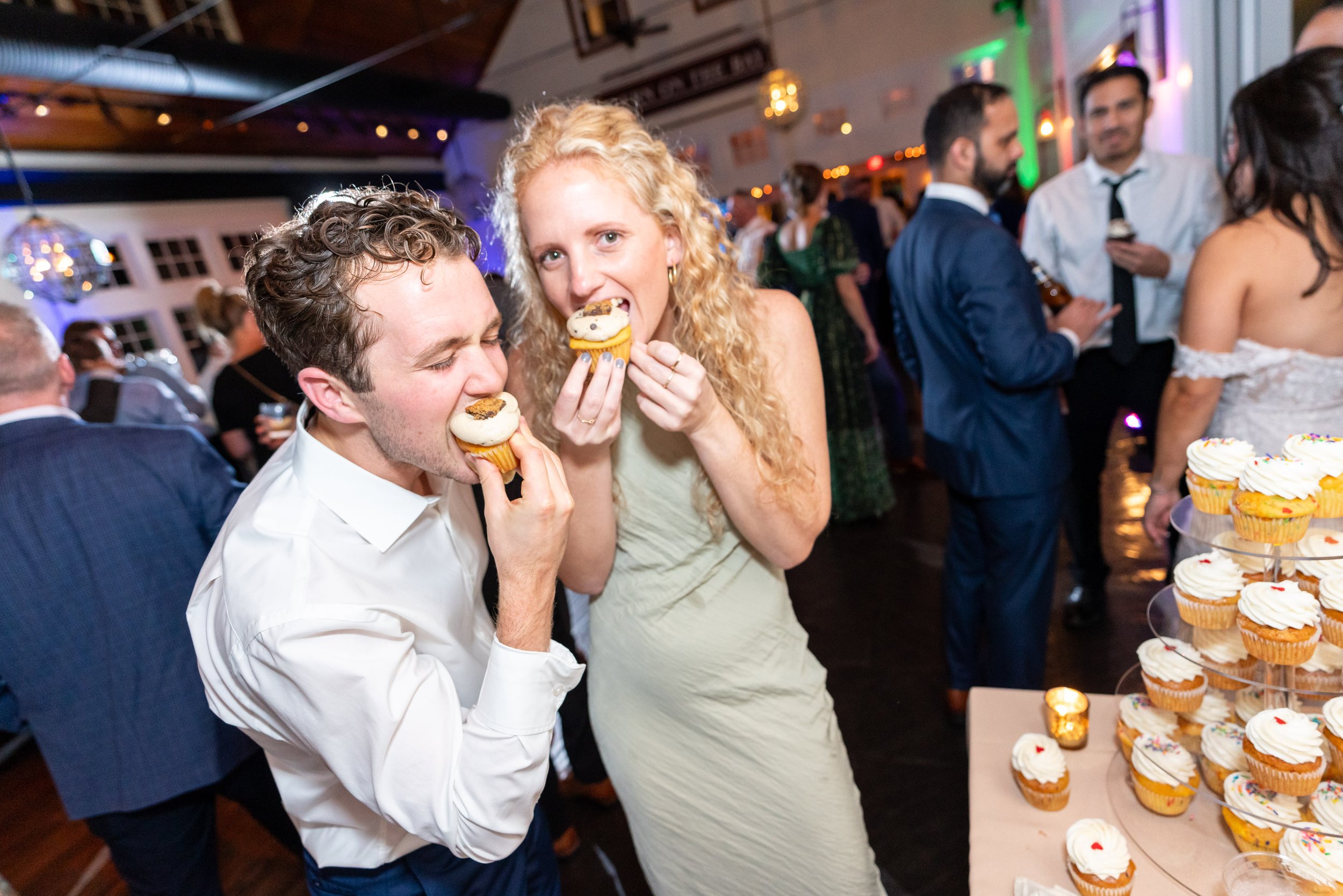 guests sharing cupcakes during wedding reception photos at Chesapeake Bay Beach Club