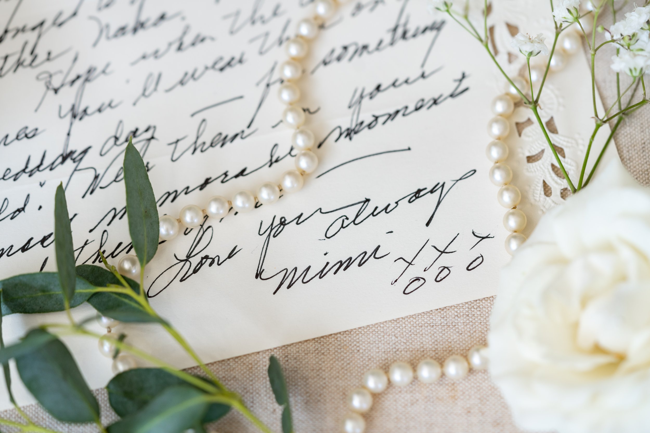 A handwritten letter to the bride from her grandmother with pearls