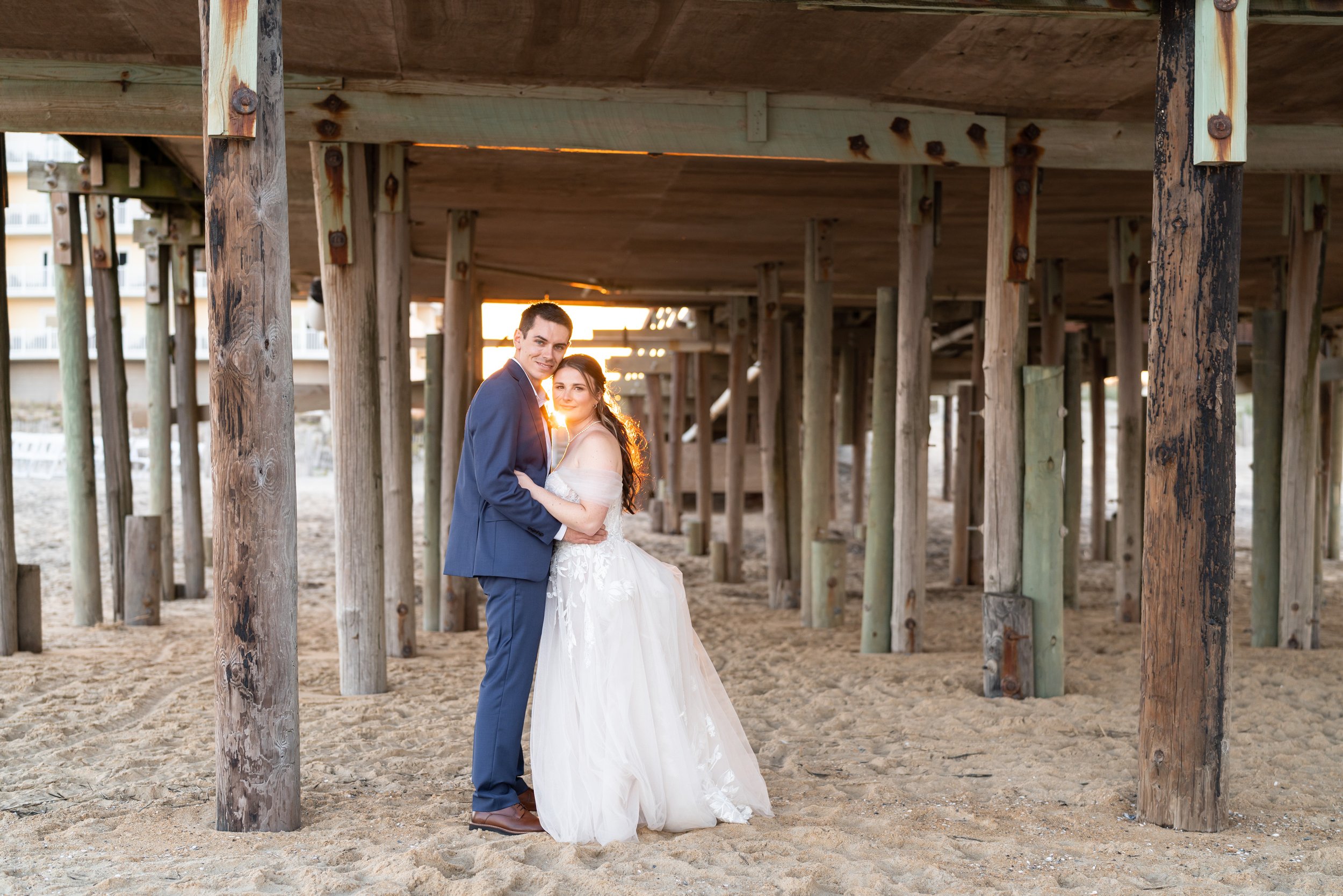 Bride and groom sunset under the kitty hawk pier outer banks nc