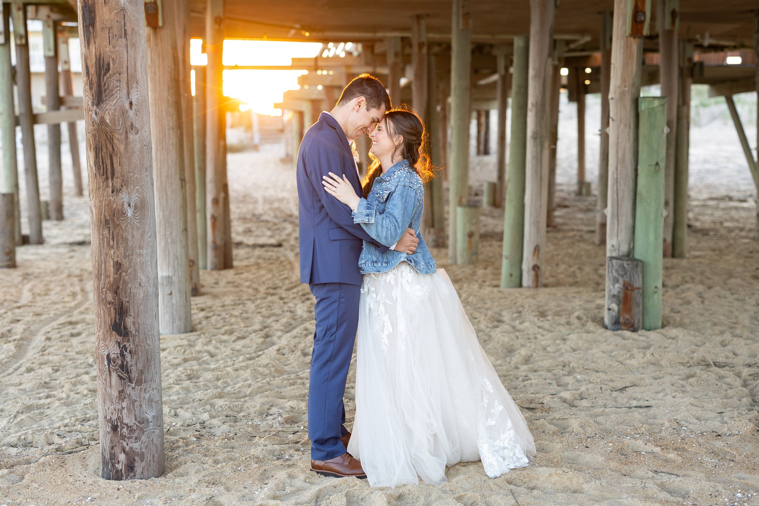 Wedding photos at sunset under the kitty hawk pier outer banks nc