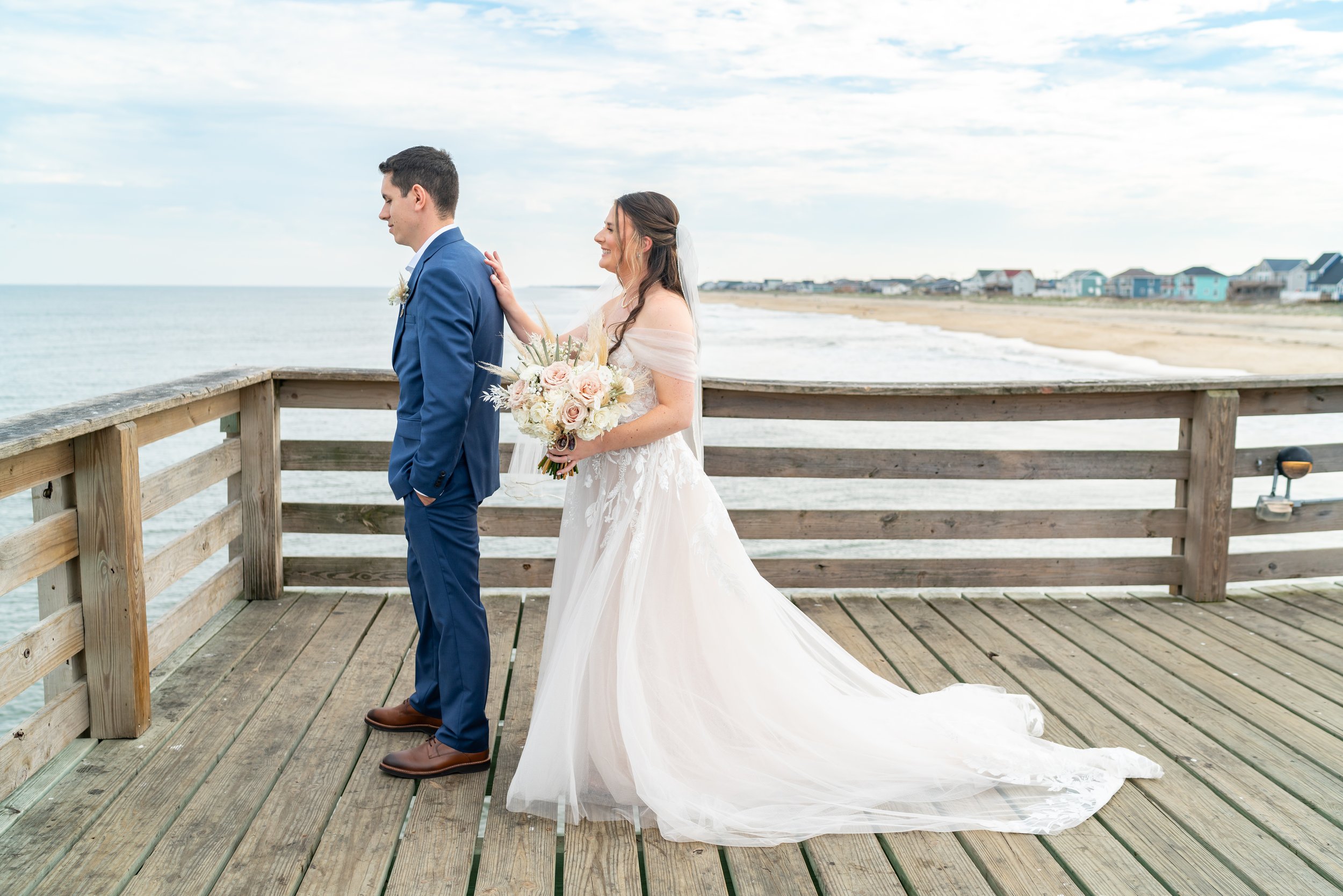 Bride and groom first look on Kitty Hawk Pier wedding photos