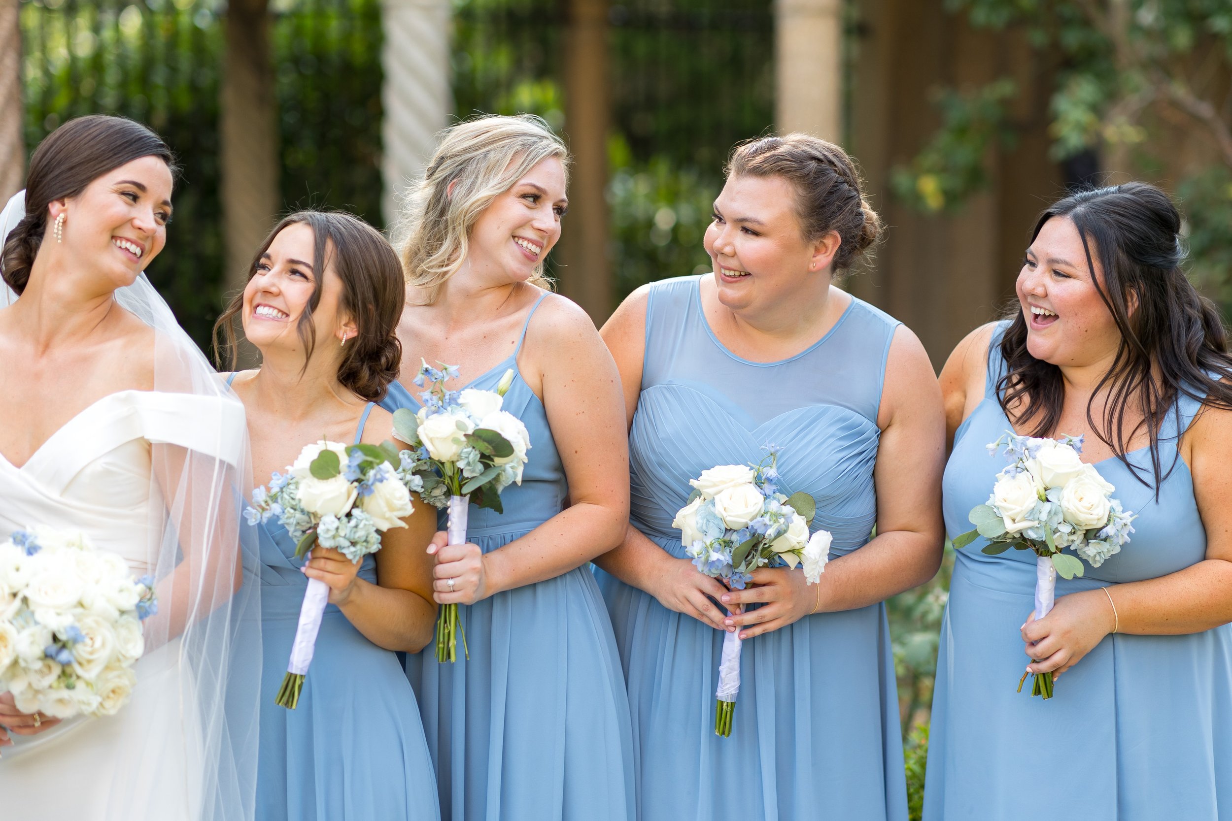 Bridesmaids and bride in light blue dresses at St Francis Hall fun wedding photography