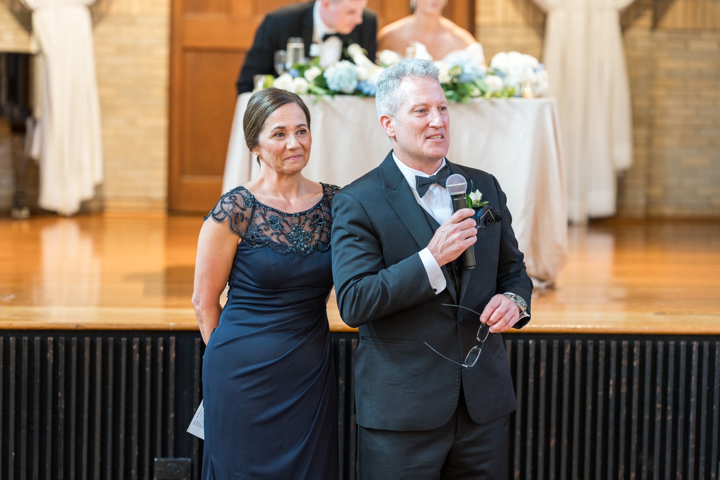 Parents of the bride give a toast by the stage at St. Francis Hall in DC