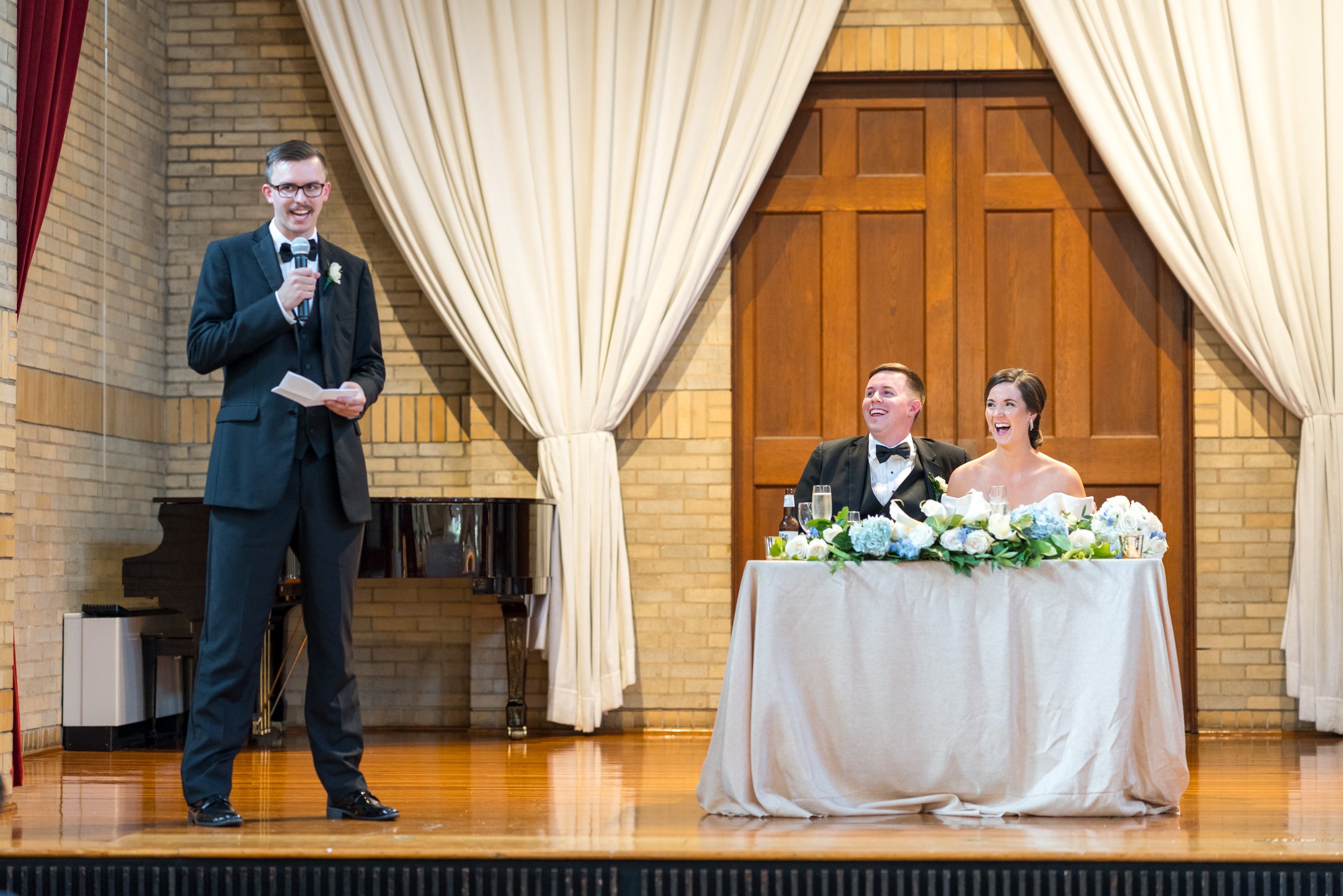 Couple laughing at best man toast during wedding at St Francis Hall in Washington DC fun wedding
