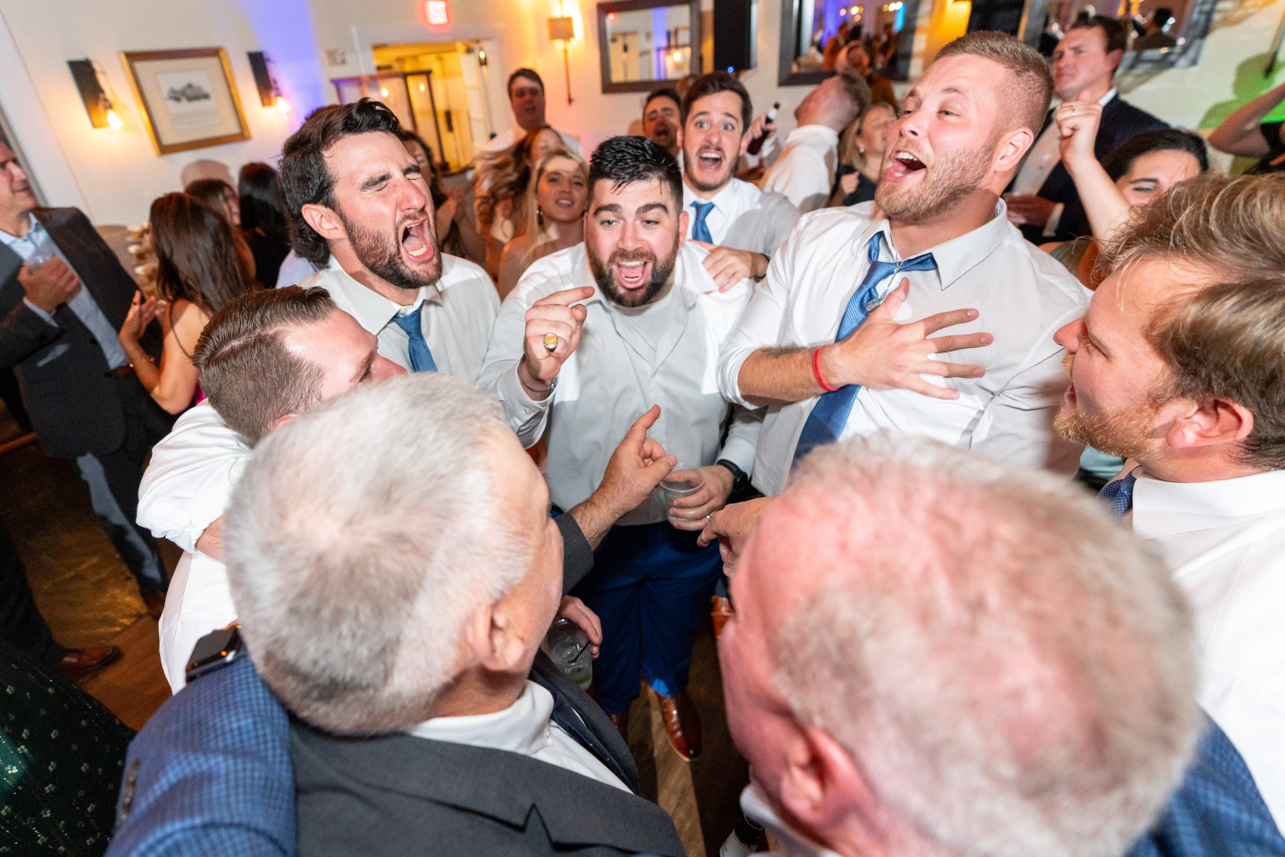 Groom and groomsmen singing on the dance floor at Chesapeake Bay beach club wedding photos