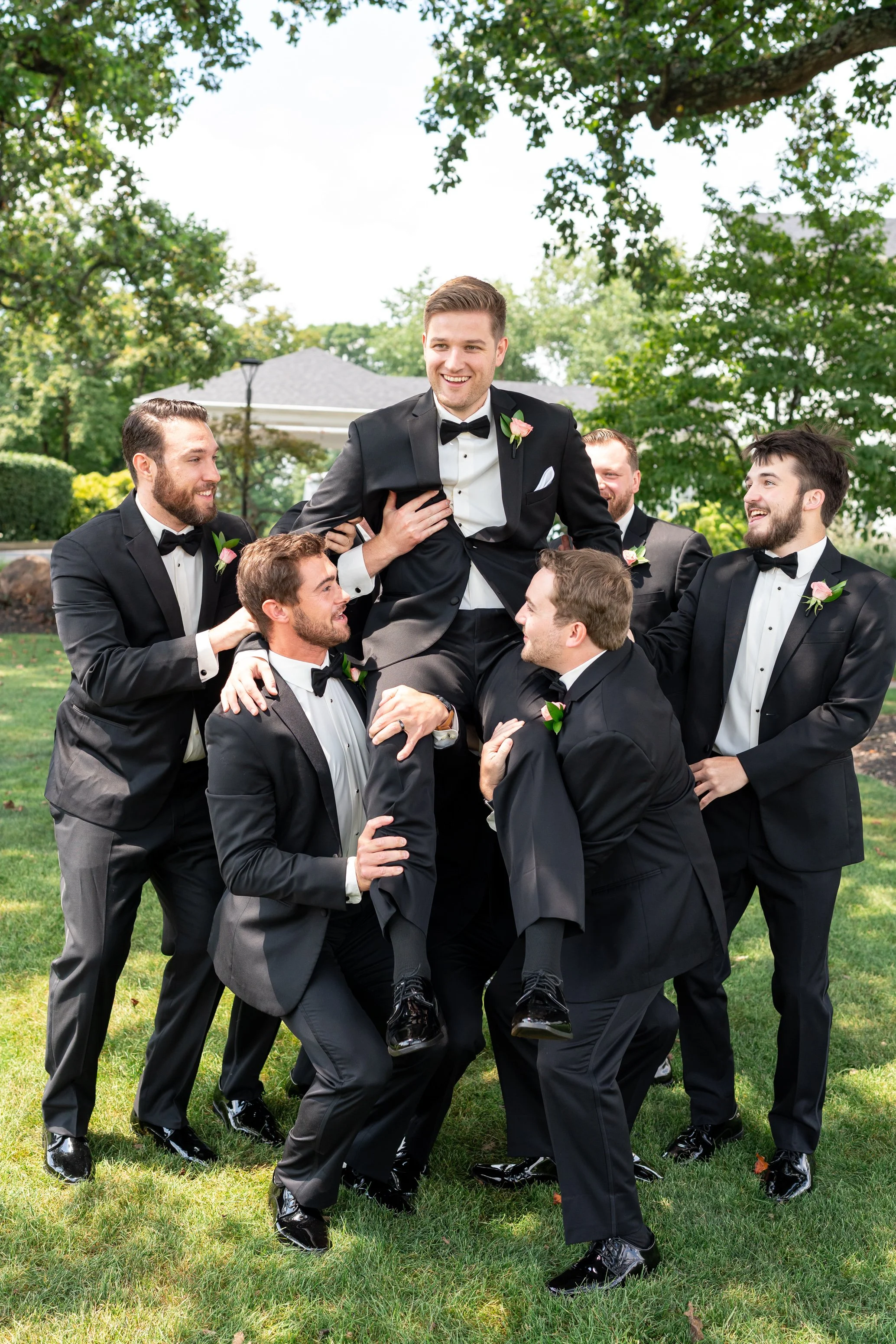 Groomsmen lifting the groom at Manor Country Club wedding