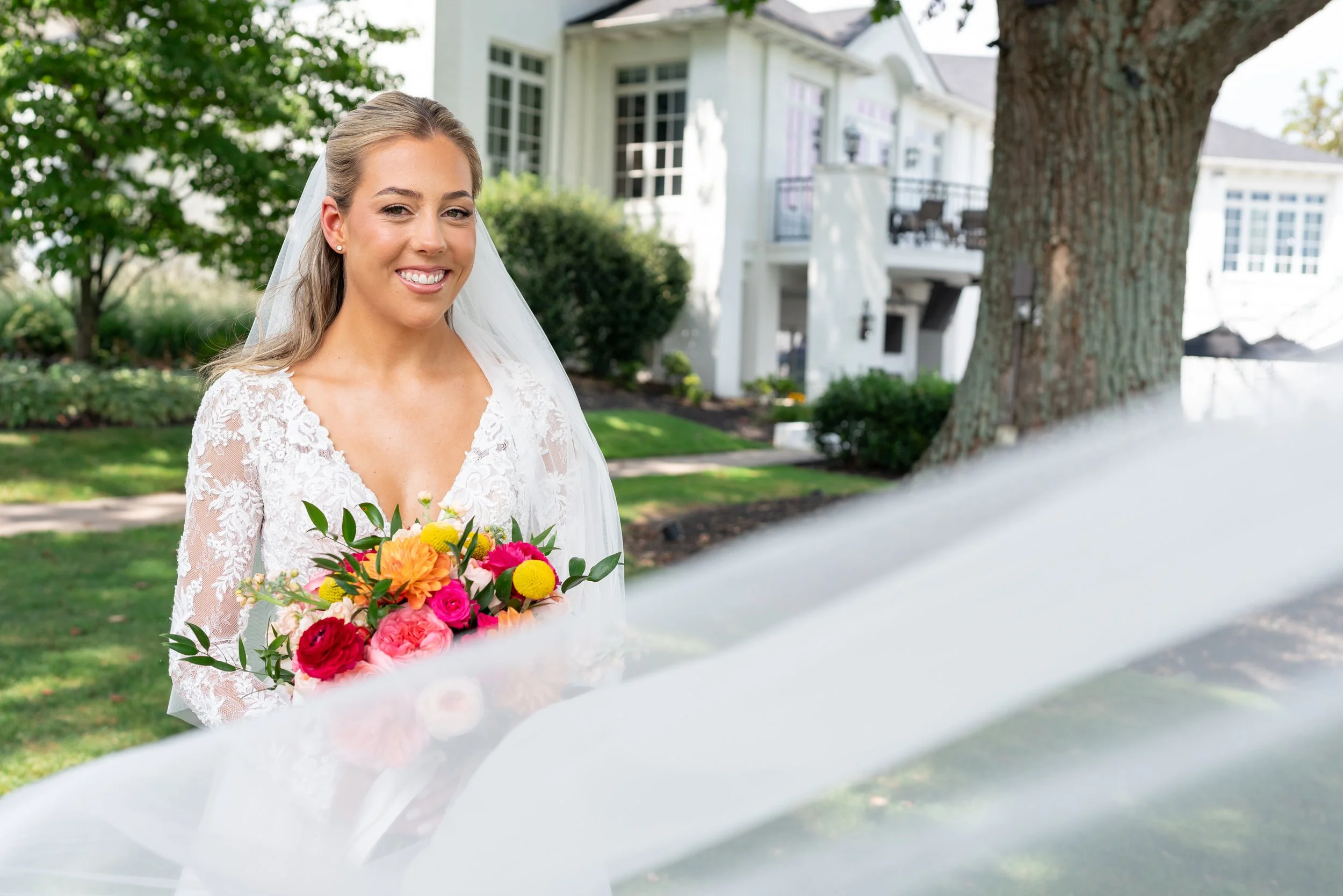 Bride smiling through her veil photo for Manor country club wedding