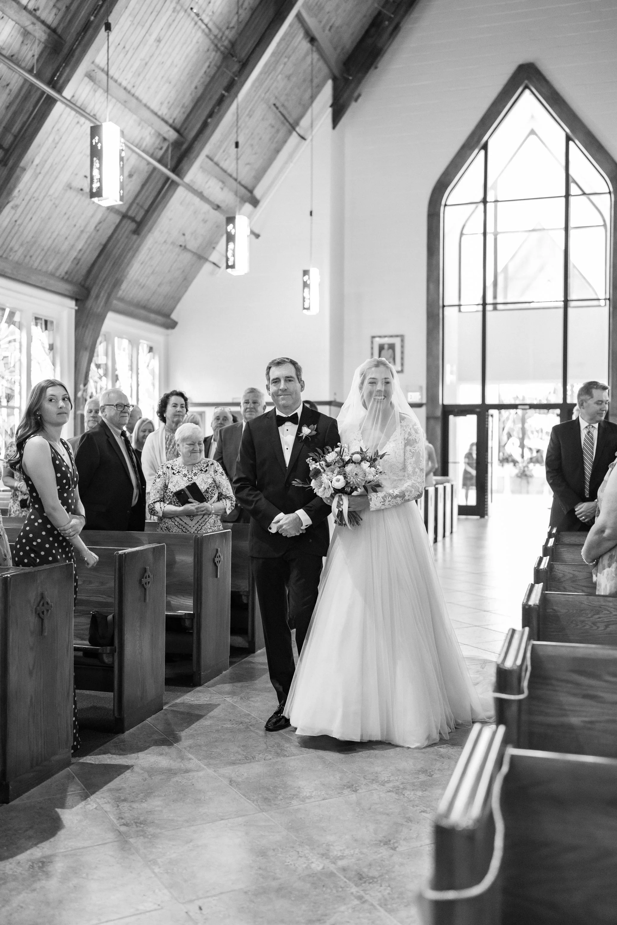 bride and her father walking down the aisle at st Patricks Catholic Church wedding in Rockville md