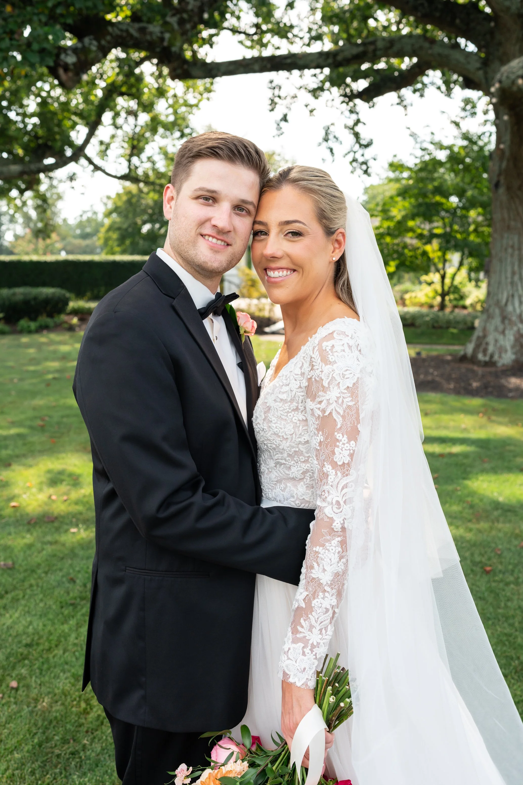 Bride and groom summer portraits under tree at Manor Country Club wedding