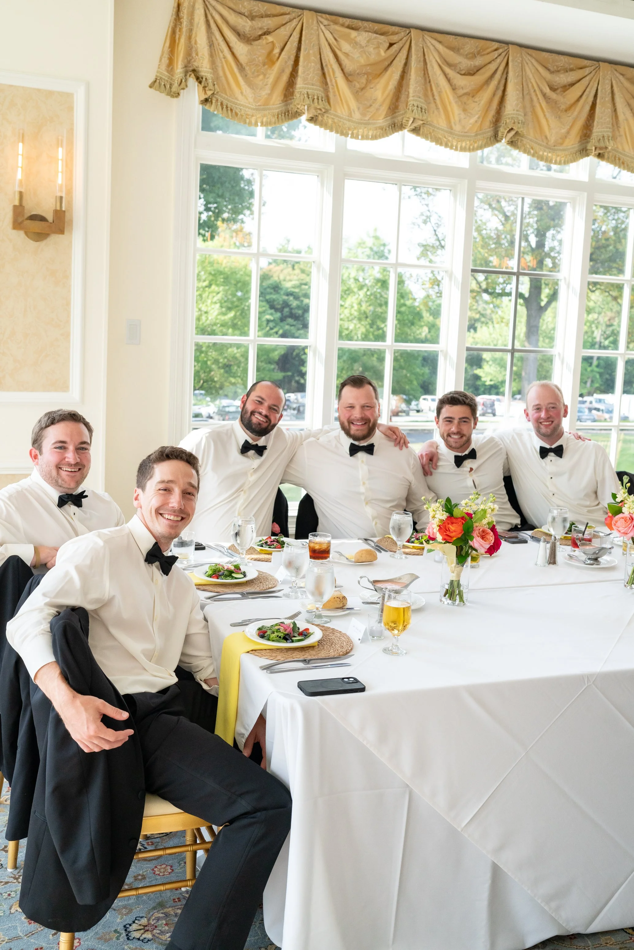 groomsmen posing and smiling for camera at Manor Country Club wedding photos