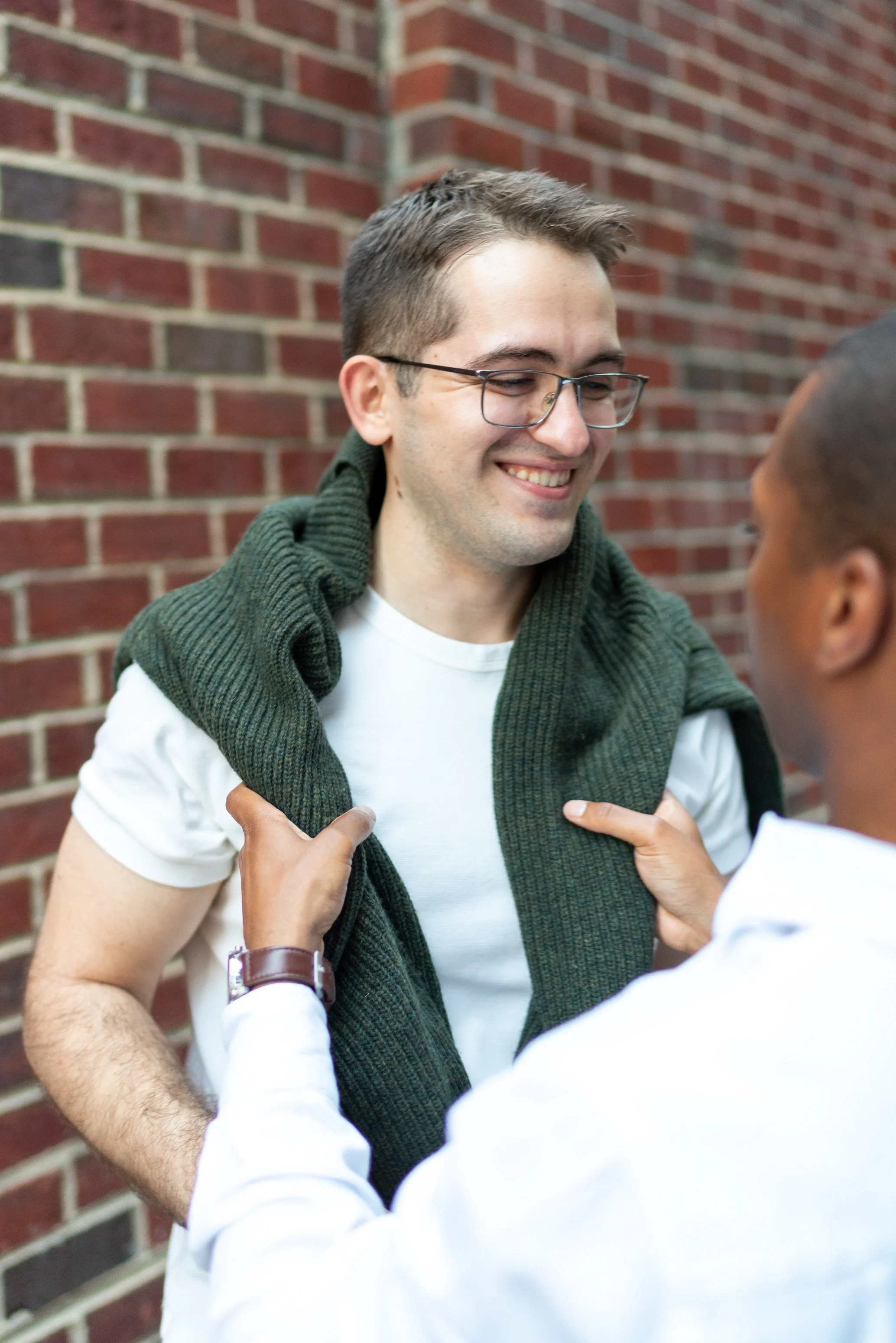 Groom adjusting sweater on his groom dc engagement session