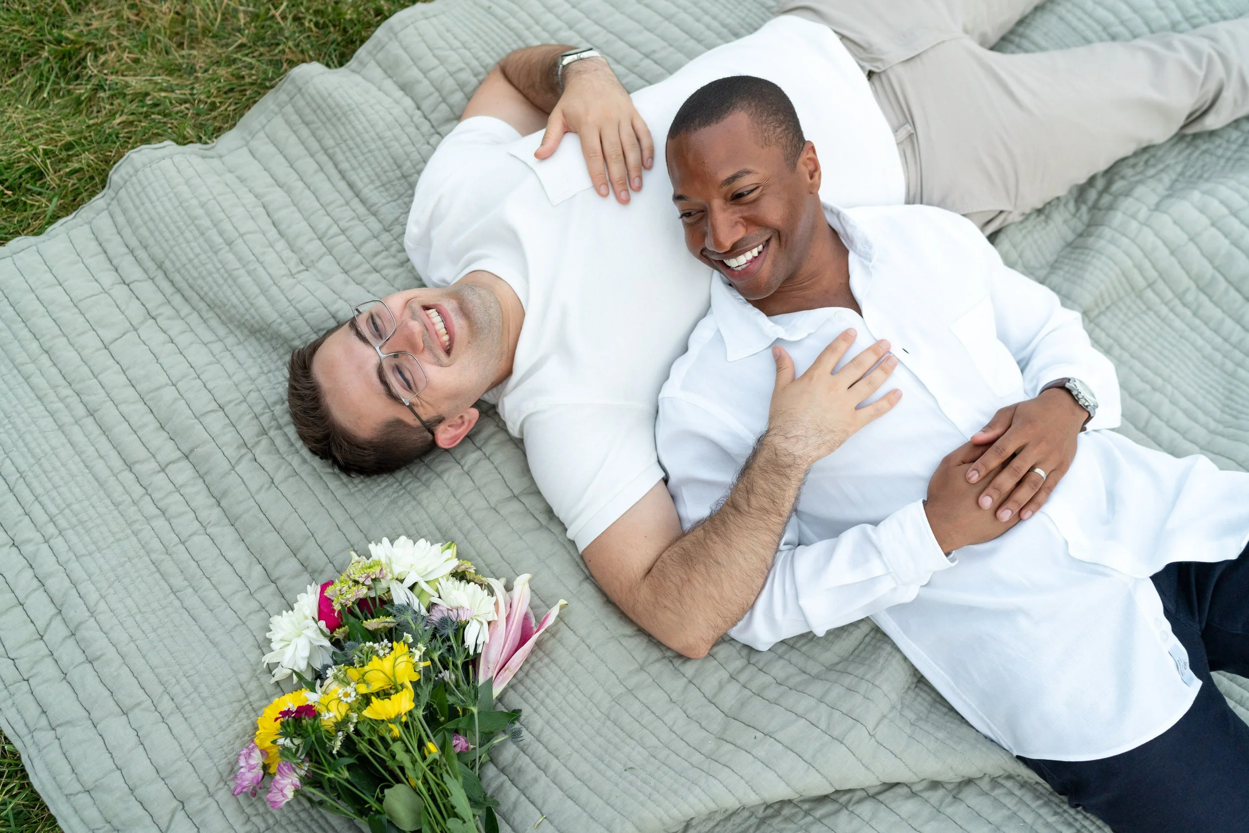 couple lying on picnic blanket engagement session waterfront Washington DC
