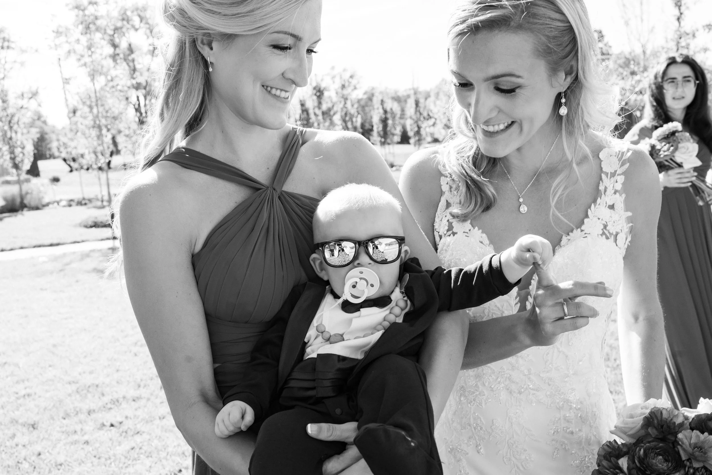Bride and her twin sister and nephew taking fun candid wedding photos in Virginia Maryland
