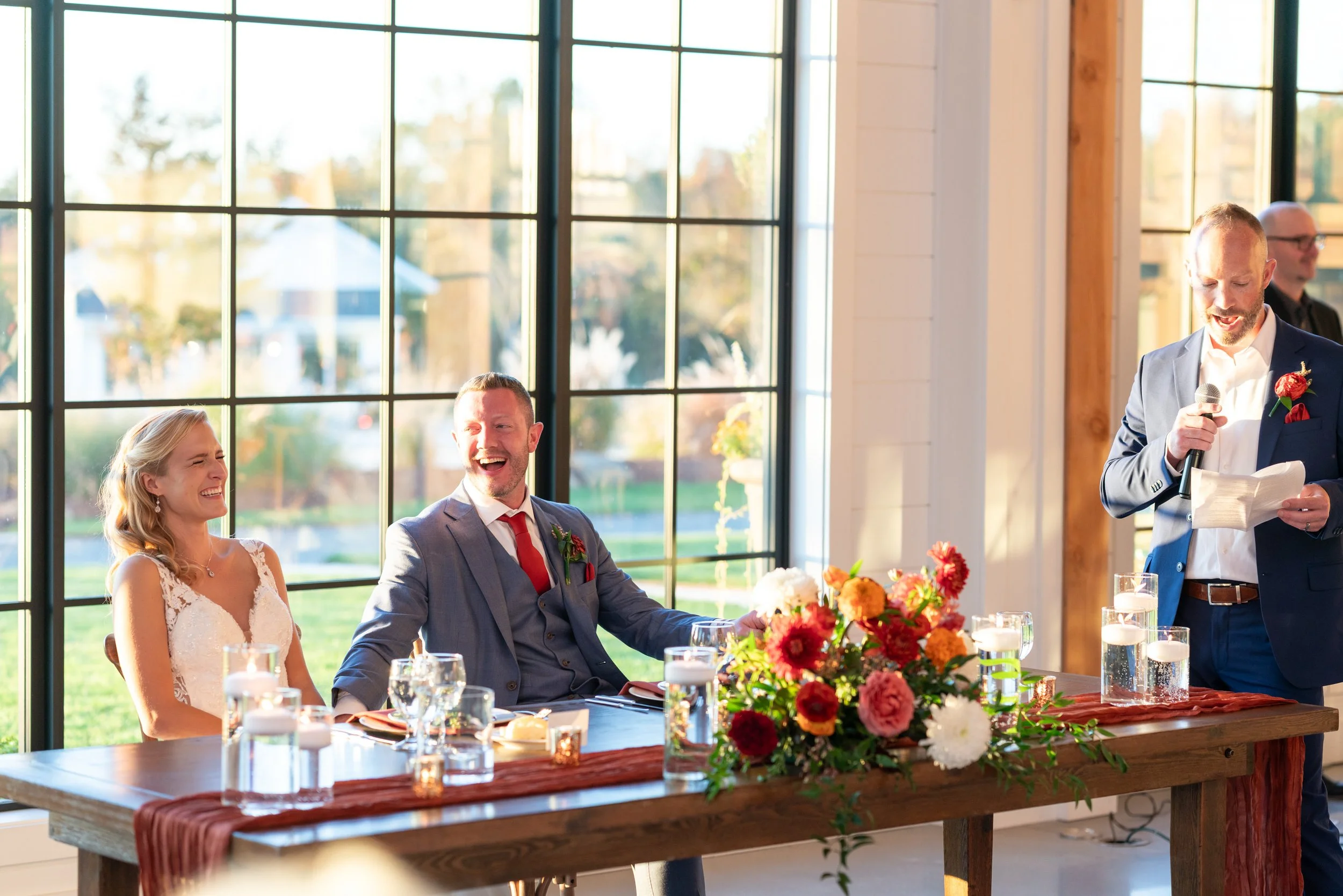 Beautiful bright colorful wedding photograph of the toasts and speeches at Hilltop Farm
