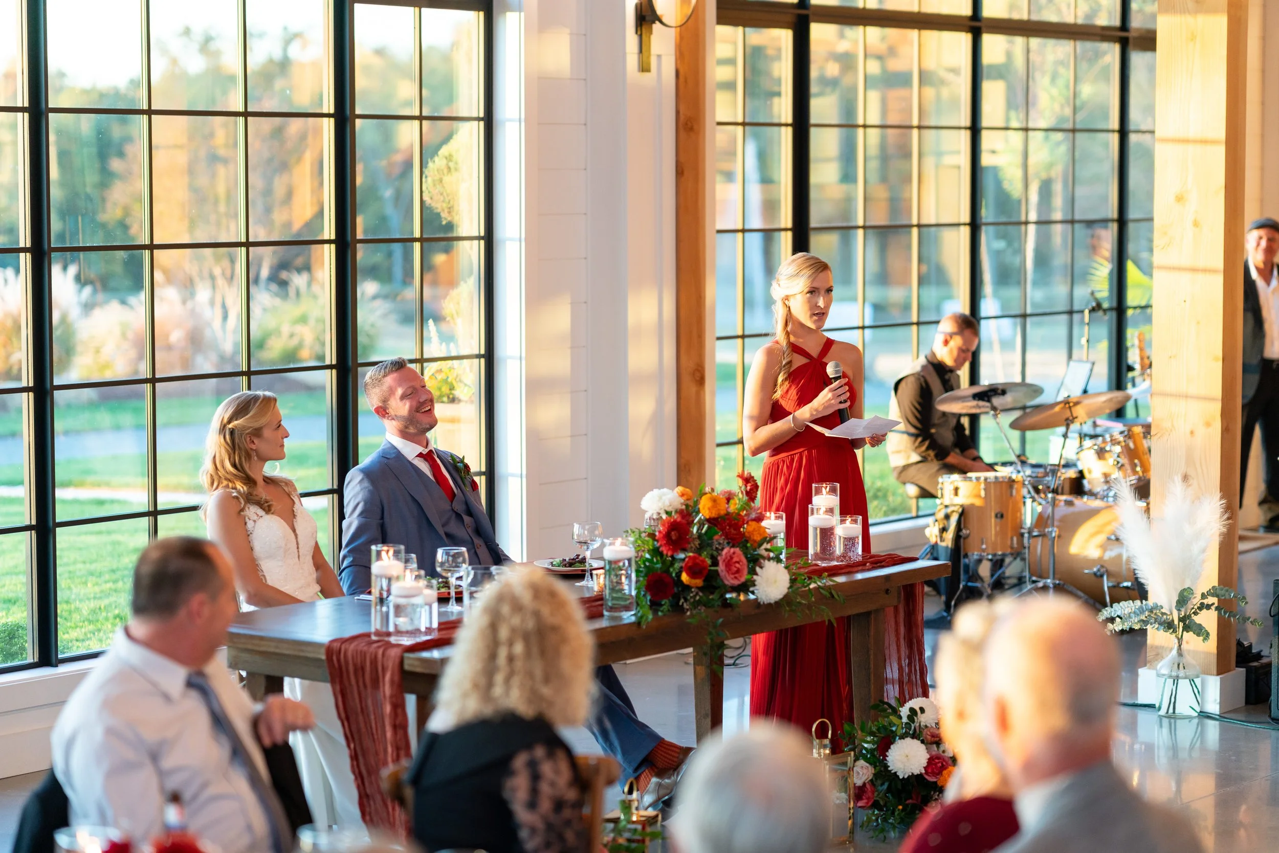 Beautiful bright colorful wedding photograph of the toasts and speeches at Hilltop Farm
