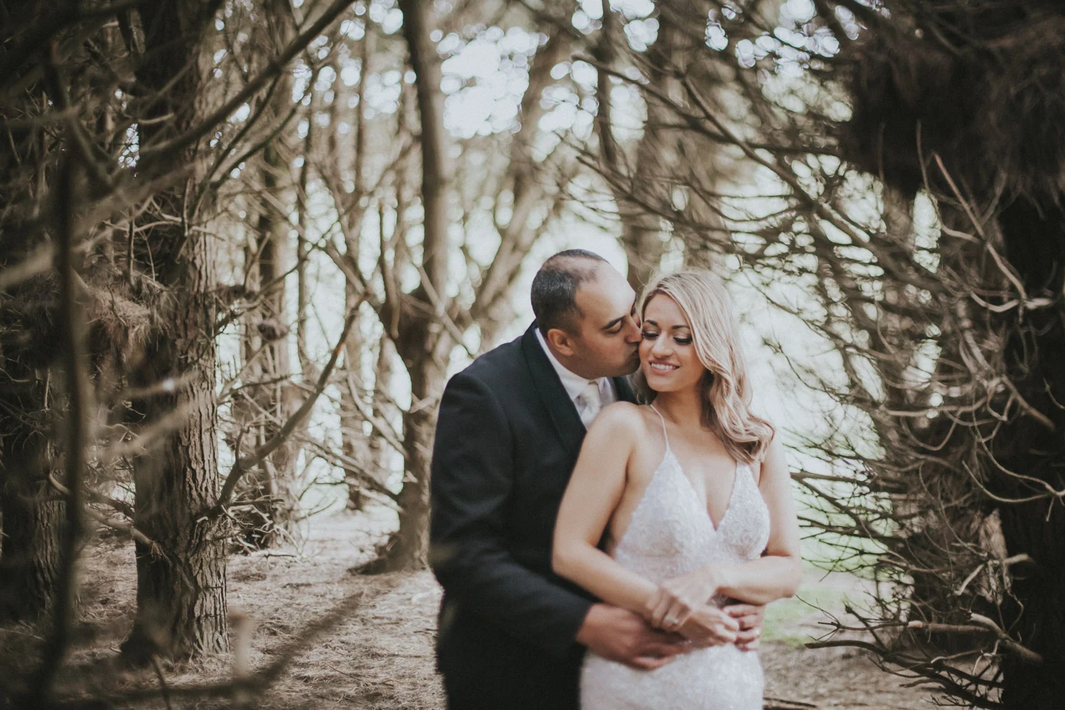 Wedding photo taken in pine tree forest