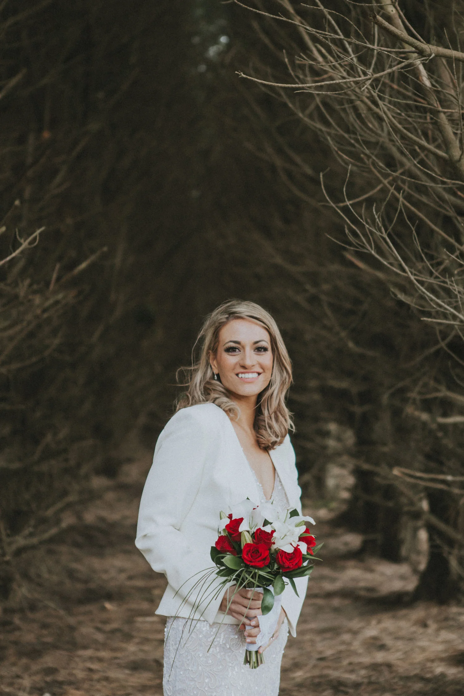 Beautiful photo of Bride standing in a pine tree forest