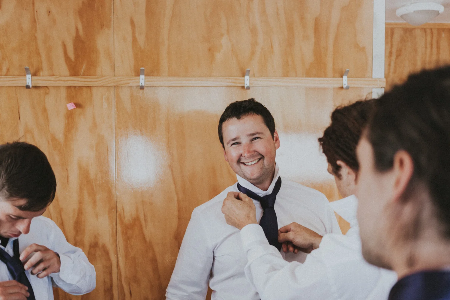 Groomsmen fixing Grooms tie 