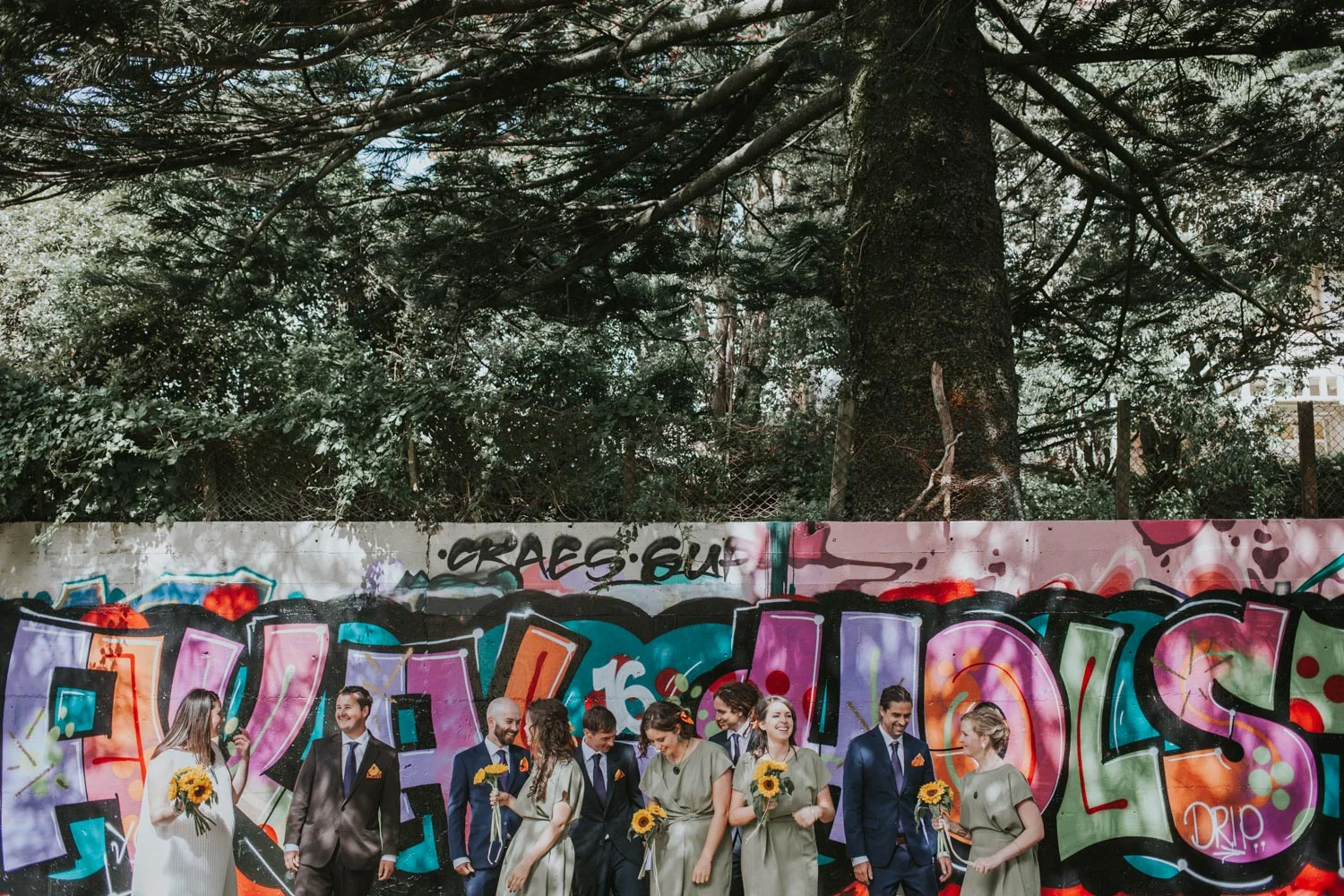 Bridal party standing in front of Graffiti wall for bridal photos