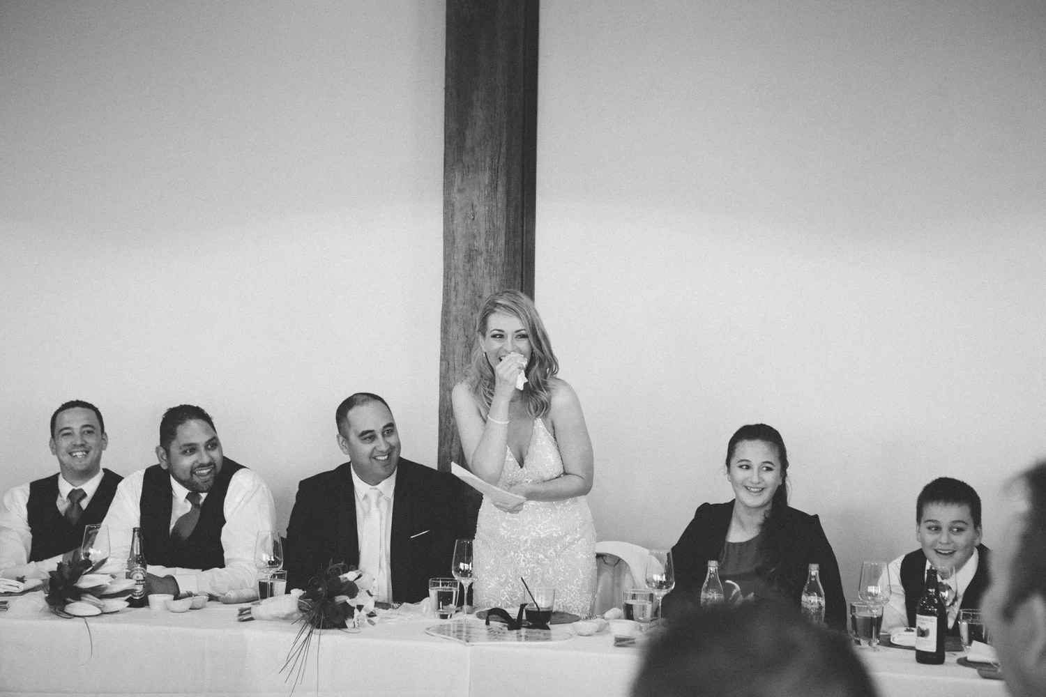 Bride laughing during reception speeches