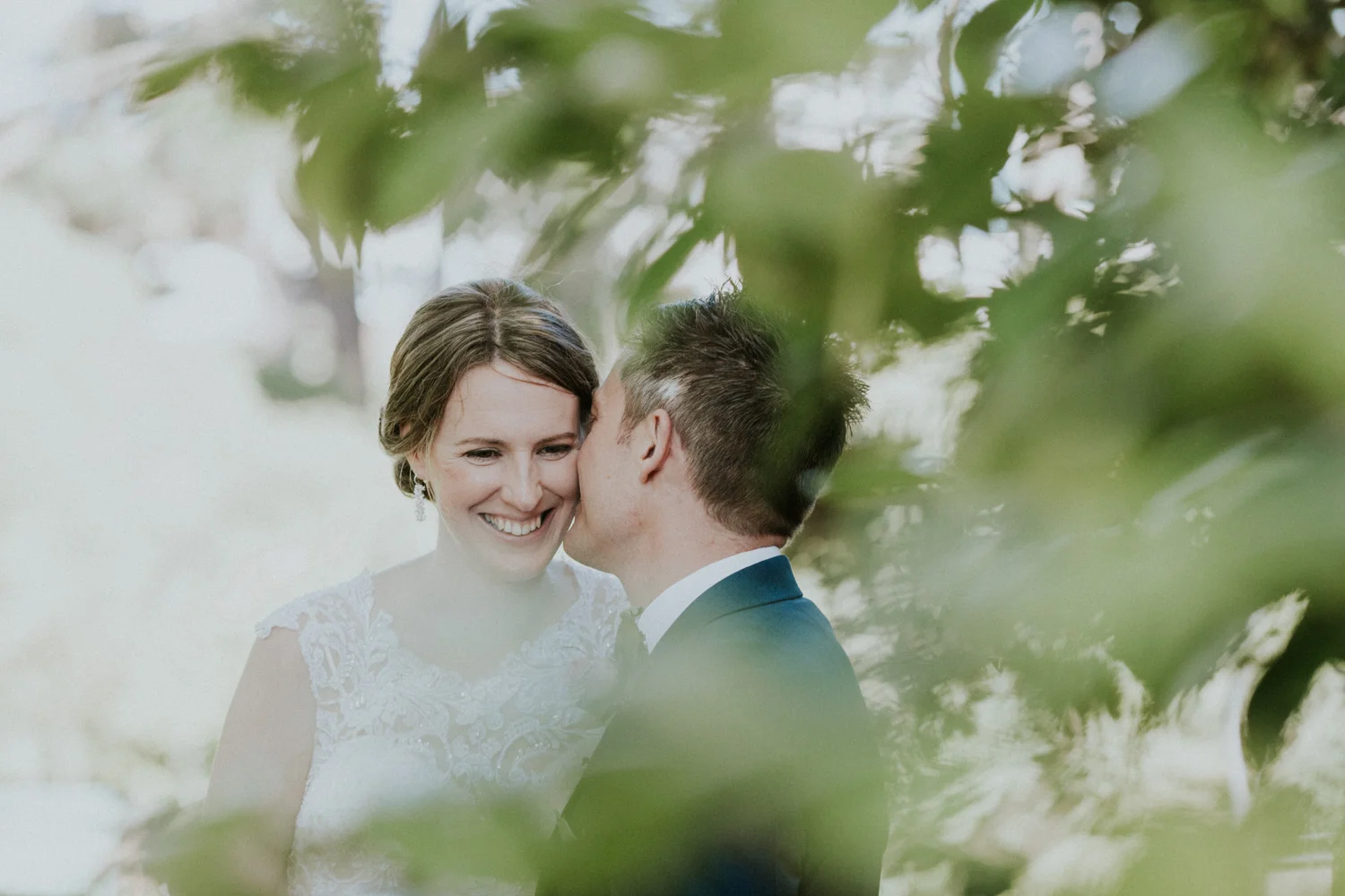 Groom kissing his bride