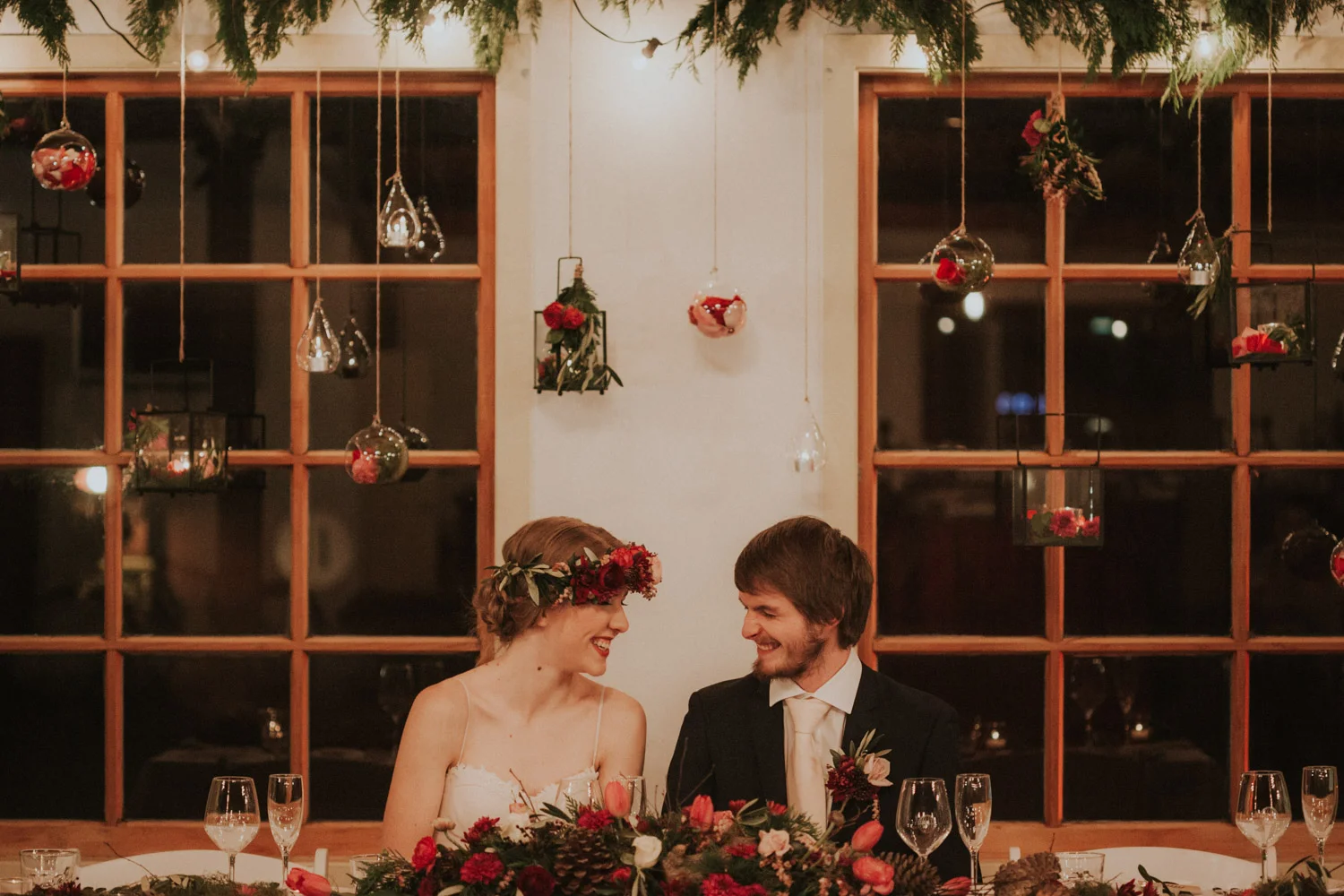 Bride and groom laughing at reception table