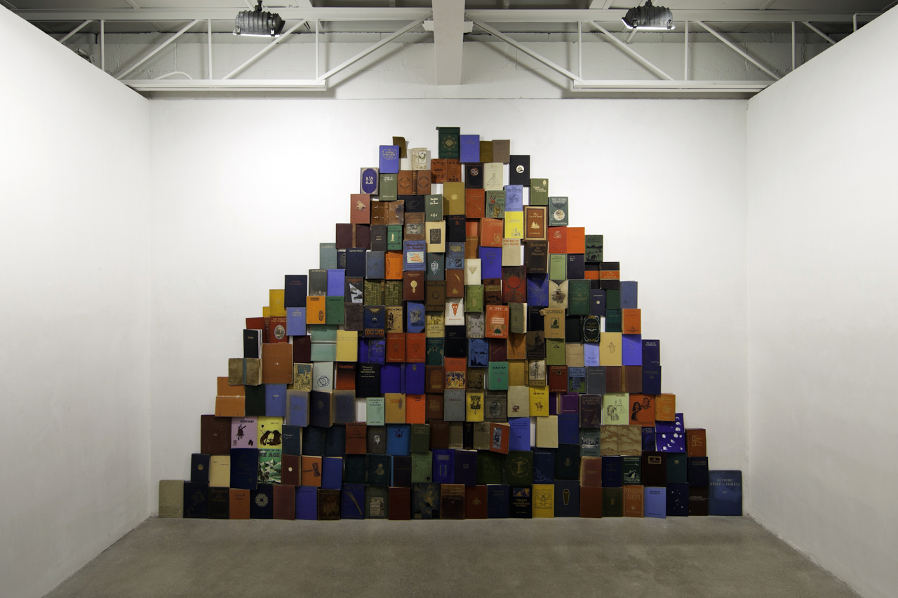 Scott Hocking, THE END OF THE WORLD, 2012. An installation of over 200 books covering destruction mythologies, eschatologies, transformations, and ideas of end times. Based on archetypal and alchemical imagery, Brueghel's Towers of Babel, and the use of the word Maya as both an ancient Mesoamerican civilization and the Hindu word meaning illusion. Along with the book mountain, the installation is accompanied by a 400 page End of the World Compendium