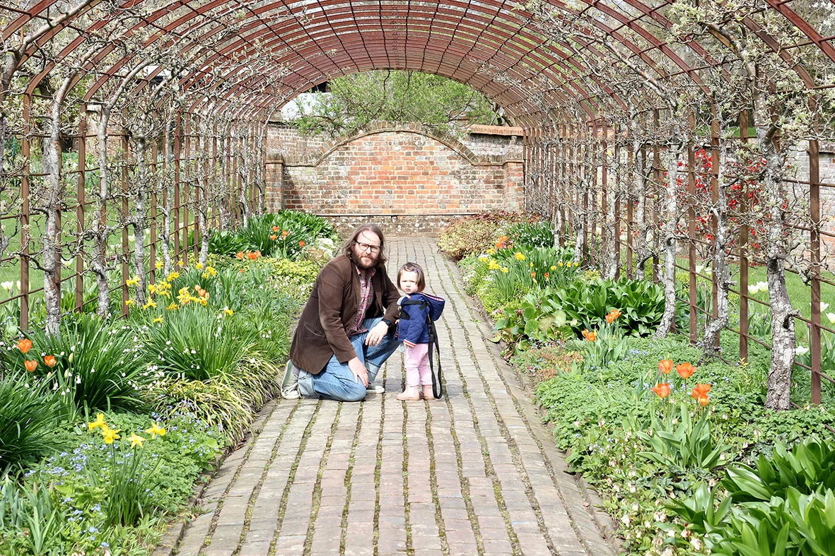 Penelope and her daddy posing within the pergola.
