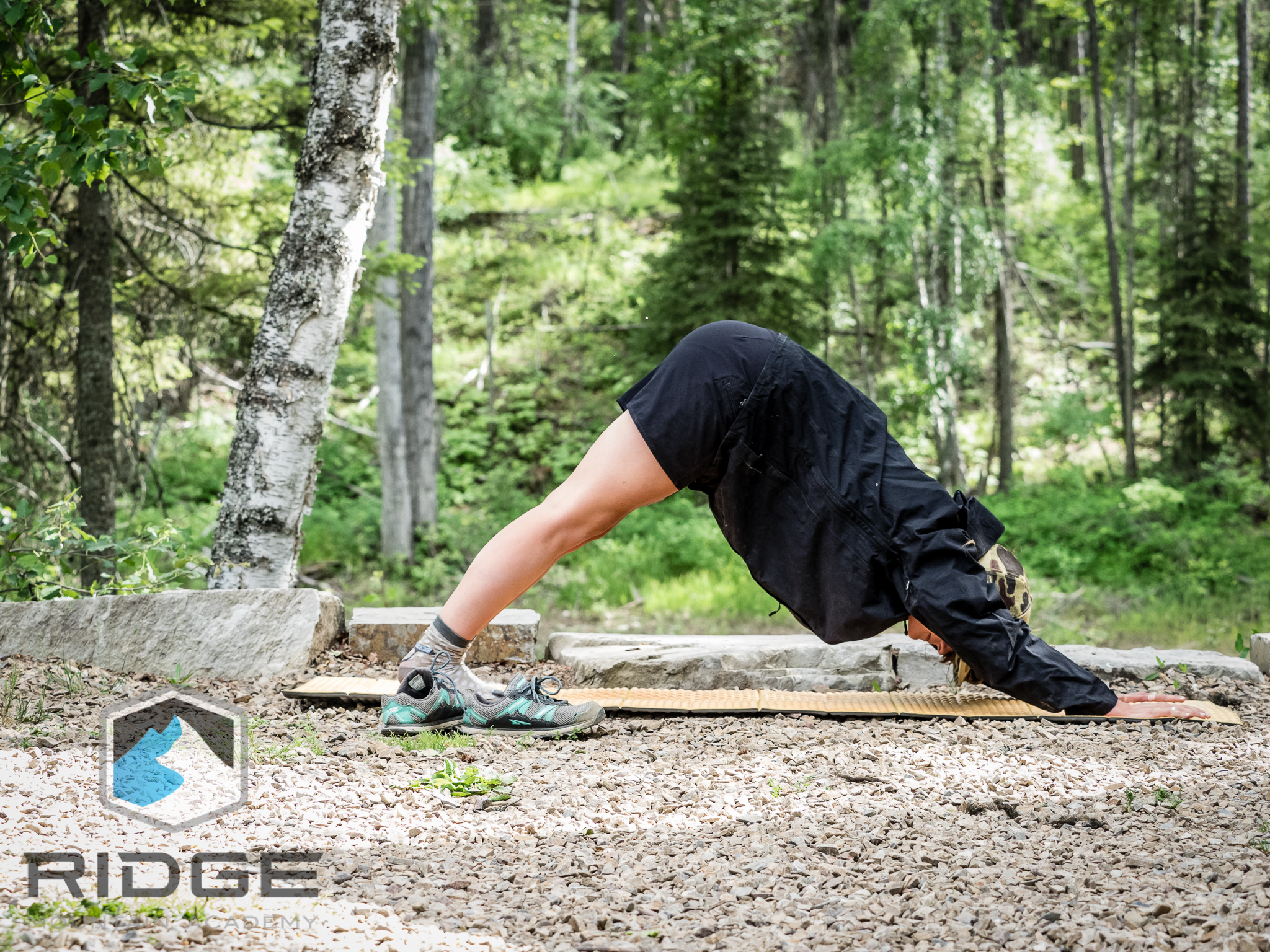 RIDGE Lead Yoga Coach, Cat Jenks, making time for downward Dog in camp.