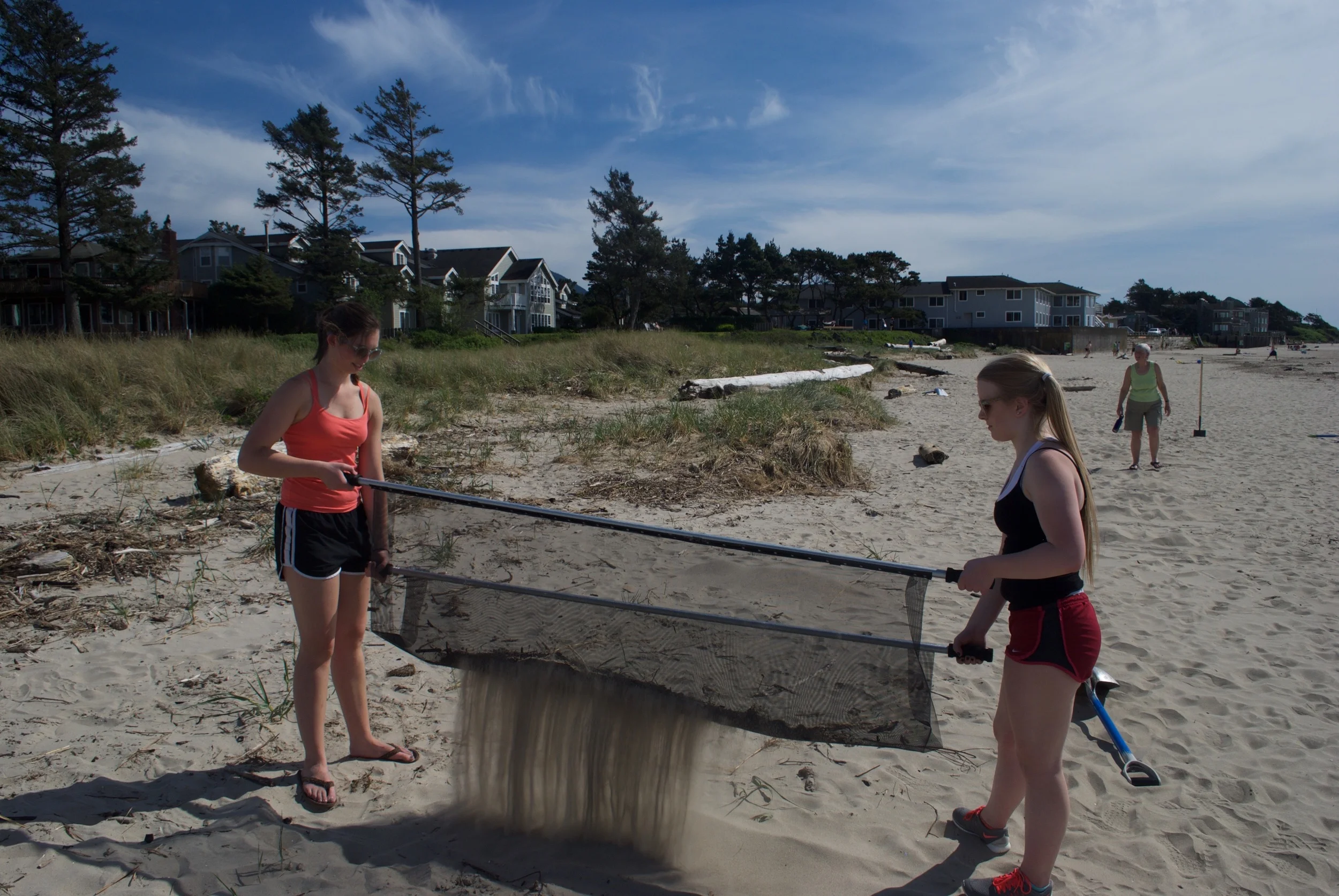Blue Wave volunteers filter sand at Cannon Beach, Oregon