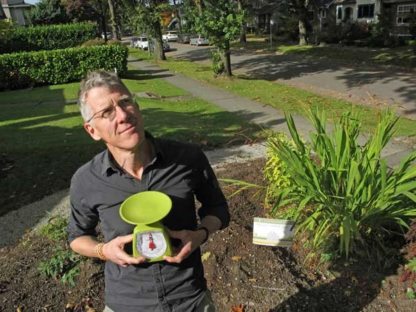 Writer Jim Boothroyd with the kitchen scale his family uses to measure out their eco footprint impact, ounce-by-ounce.