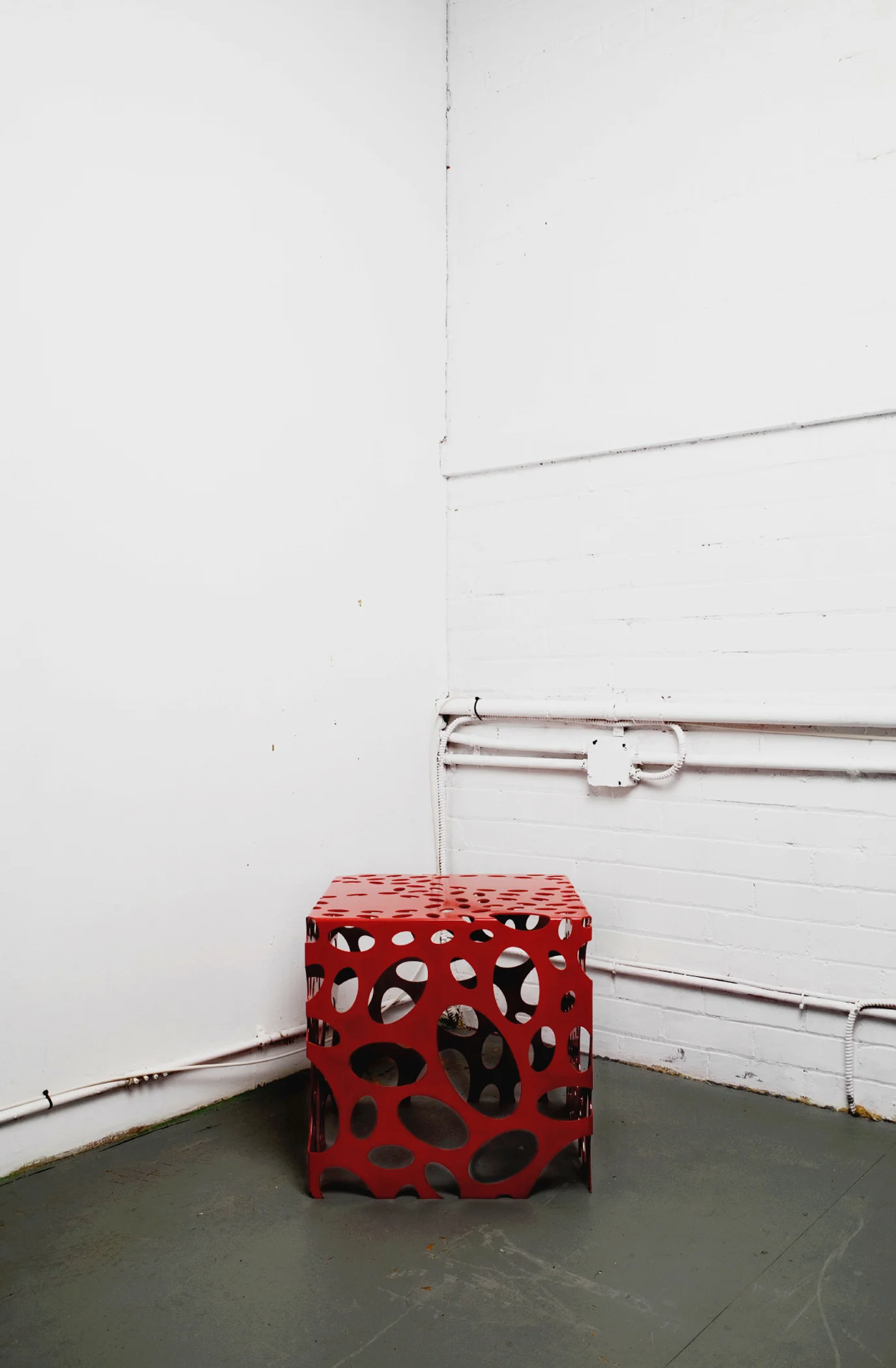Mitosis Furniture are laser-cut, break-formed, welded and powder-coated steel pieces, which serve as studies of positive and negative space, as well as experimentations of light and shadow, while fusing both art and science. Mitosis Small Cube: 18”W x 18”L x 18”H. Photo by Lucas Collins. 