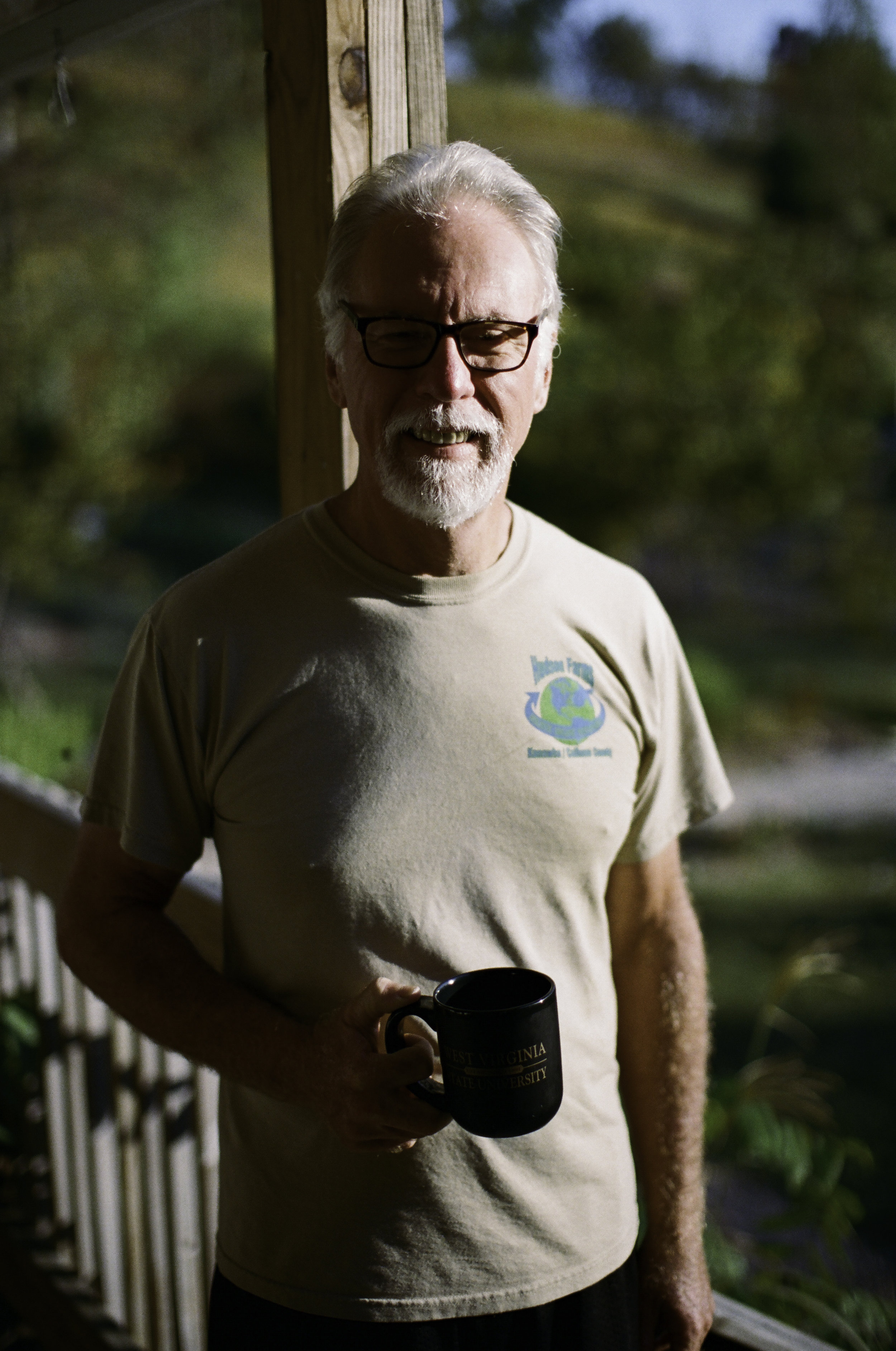  Terry Hudson on his front porch.&nbsp;"A guy once told me you want to plant trees you never get to sit under the shade of.” 